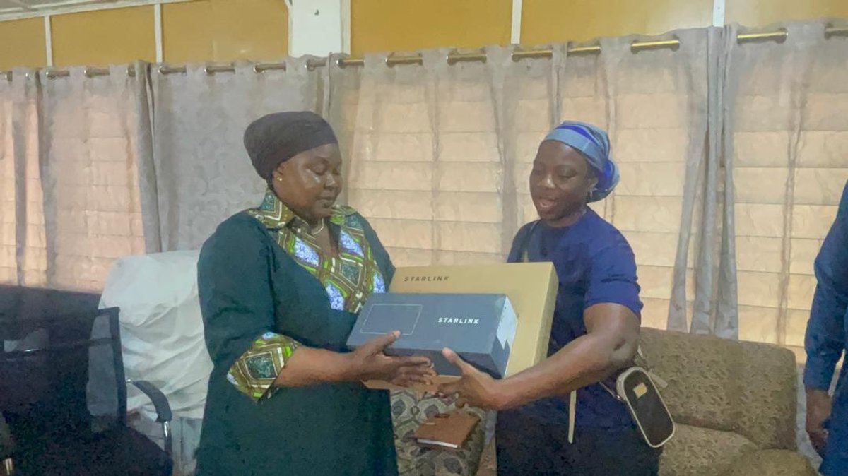 Two people completing a Starlink equipment handover, Upper West Region