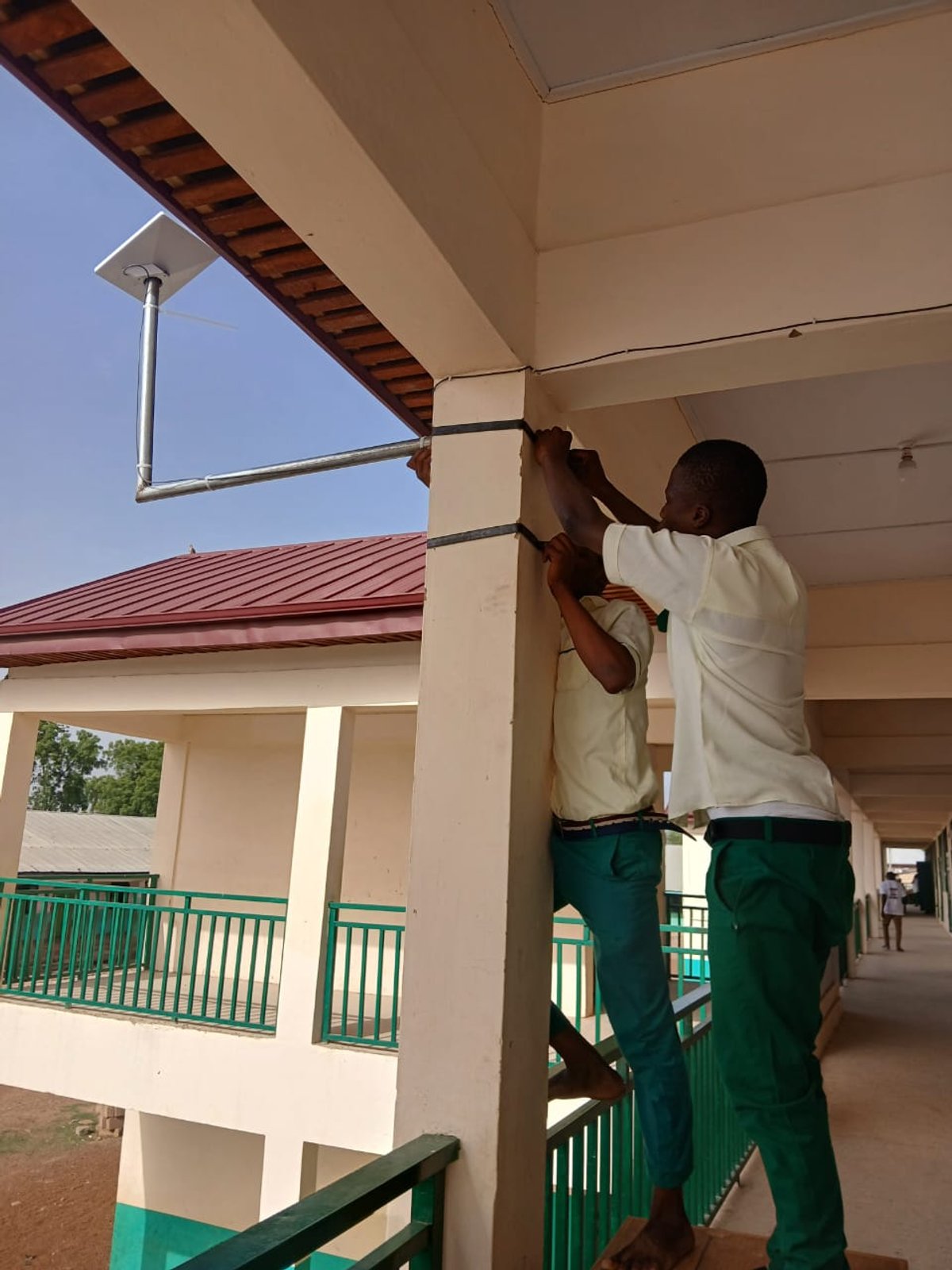 Starlink satellite dish being installed on school rooftop, Upper West Region