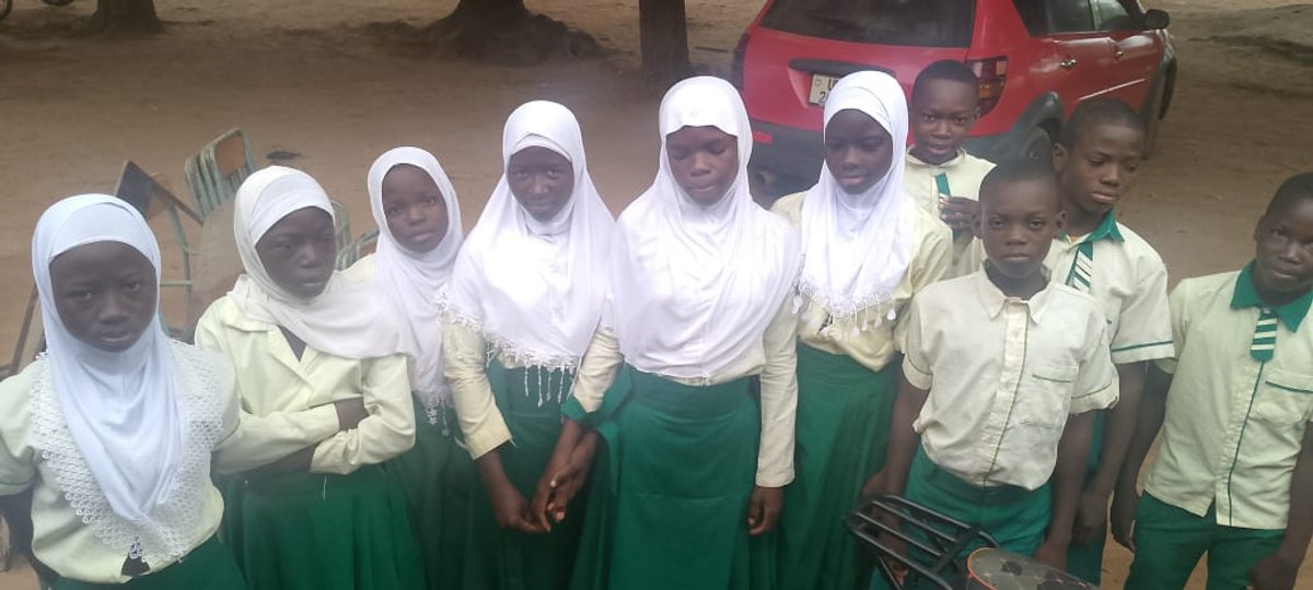 Students in hijabs performing Kpongu cultural sign language, Upper West Region