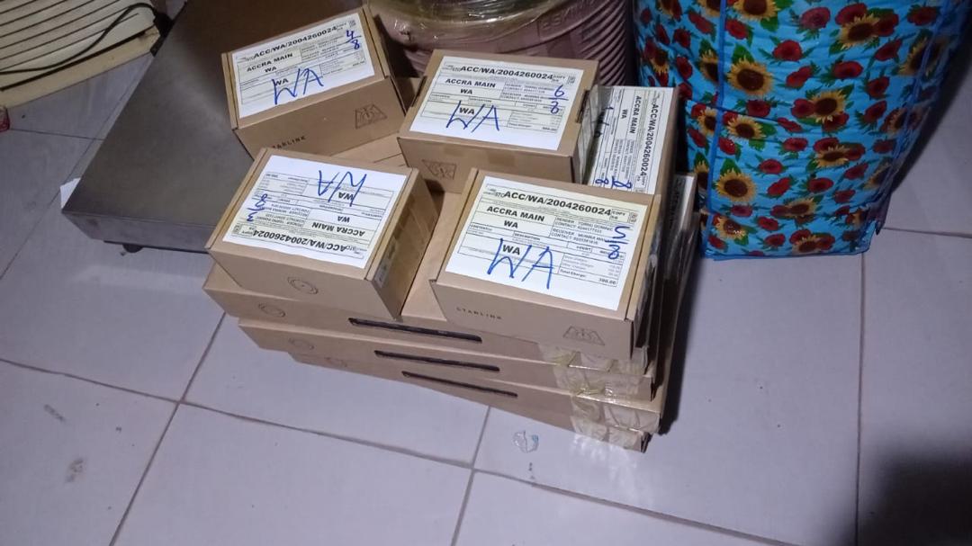 Starlink boxes labeled WA on the floor, ready for school distribution