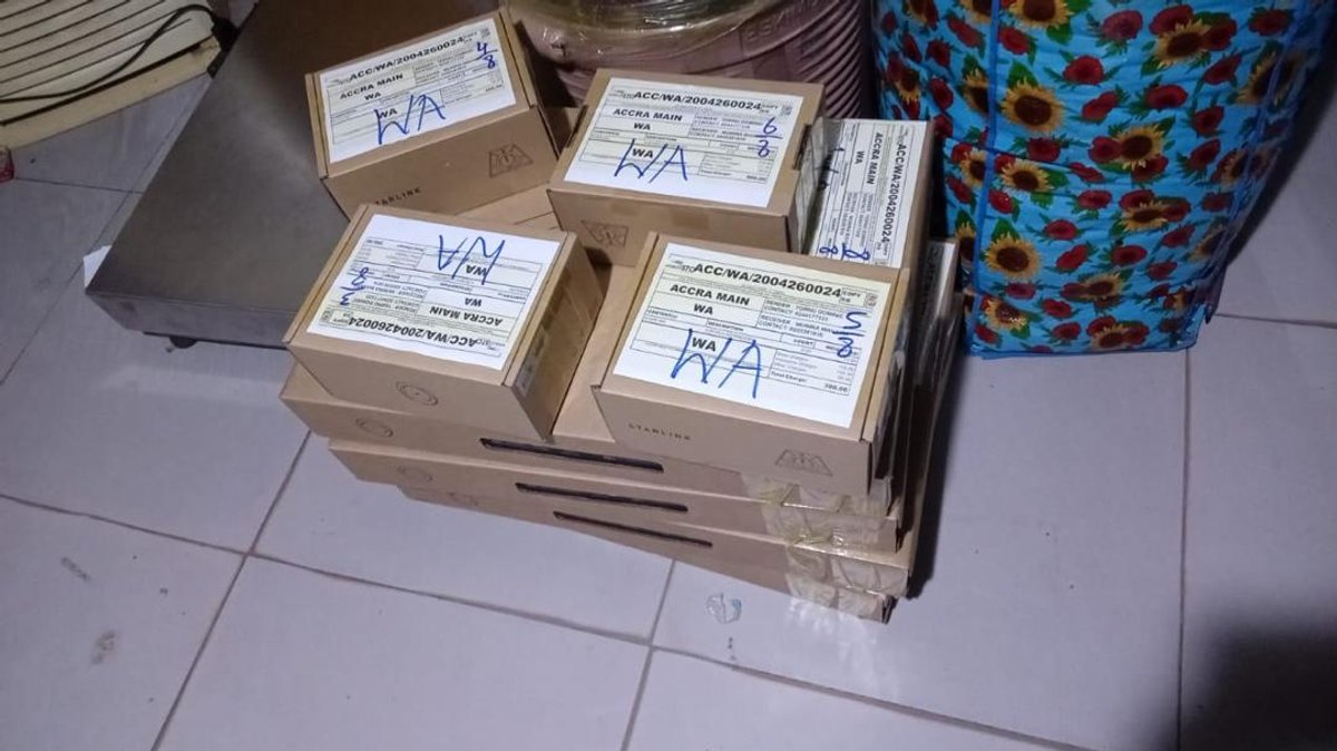 Starlink boxes labeled WA on the floor, ready for school distribution