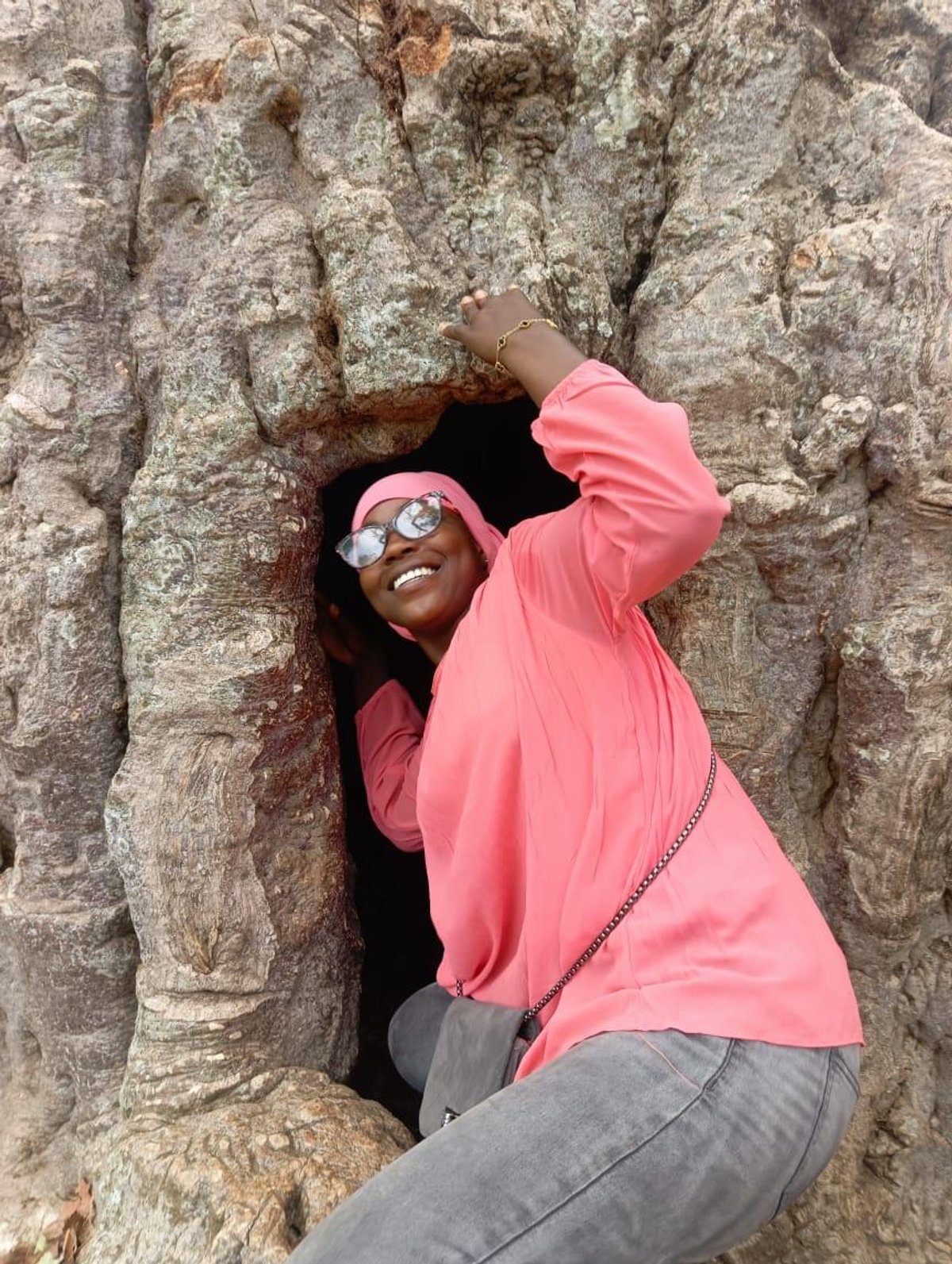 KAPAW team member posing inside the hollow of the historic Baobab tree in Busa
