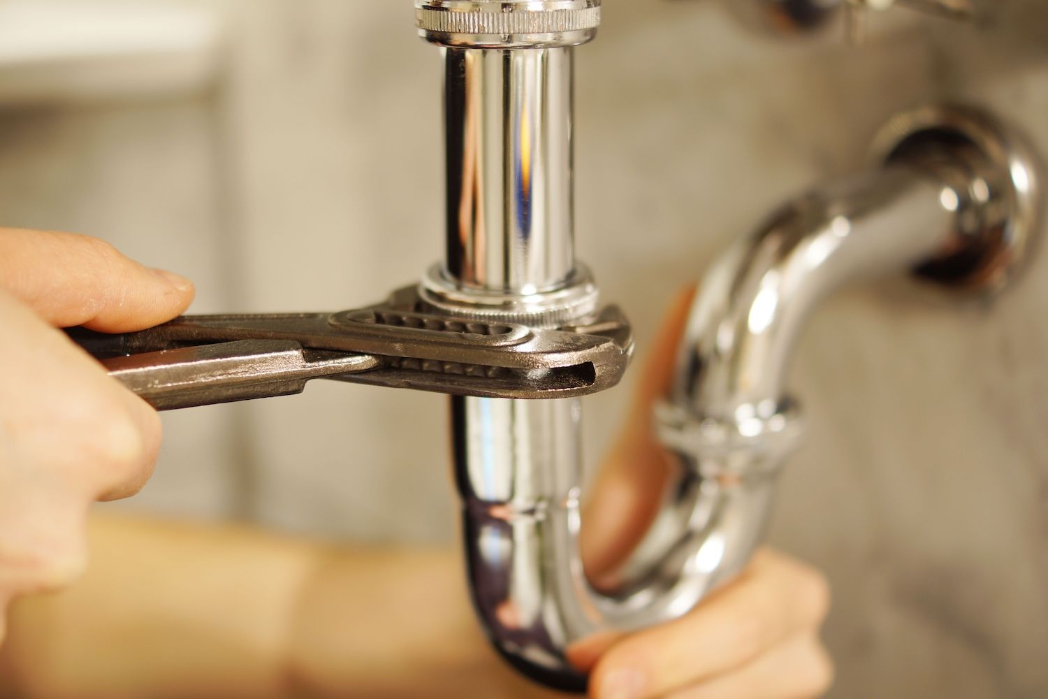 cleaning the sink trap under a kitchen or bathroom sink