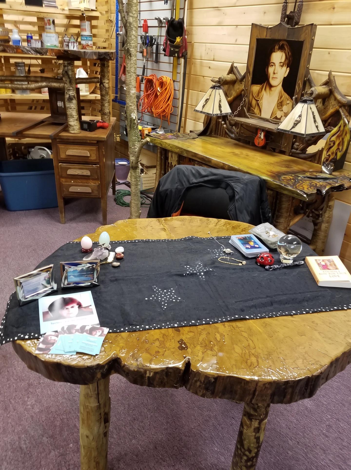 Tarot reading table prepared with cards and crystals inside a metaphysical shop
