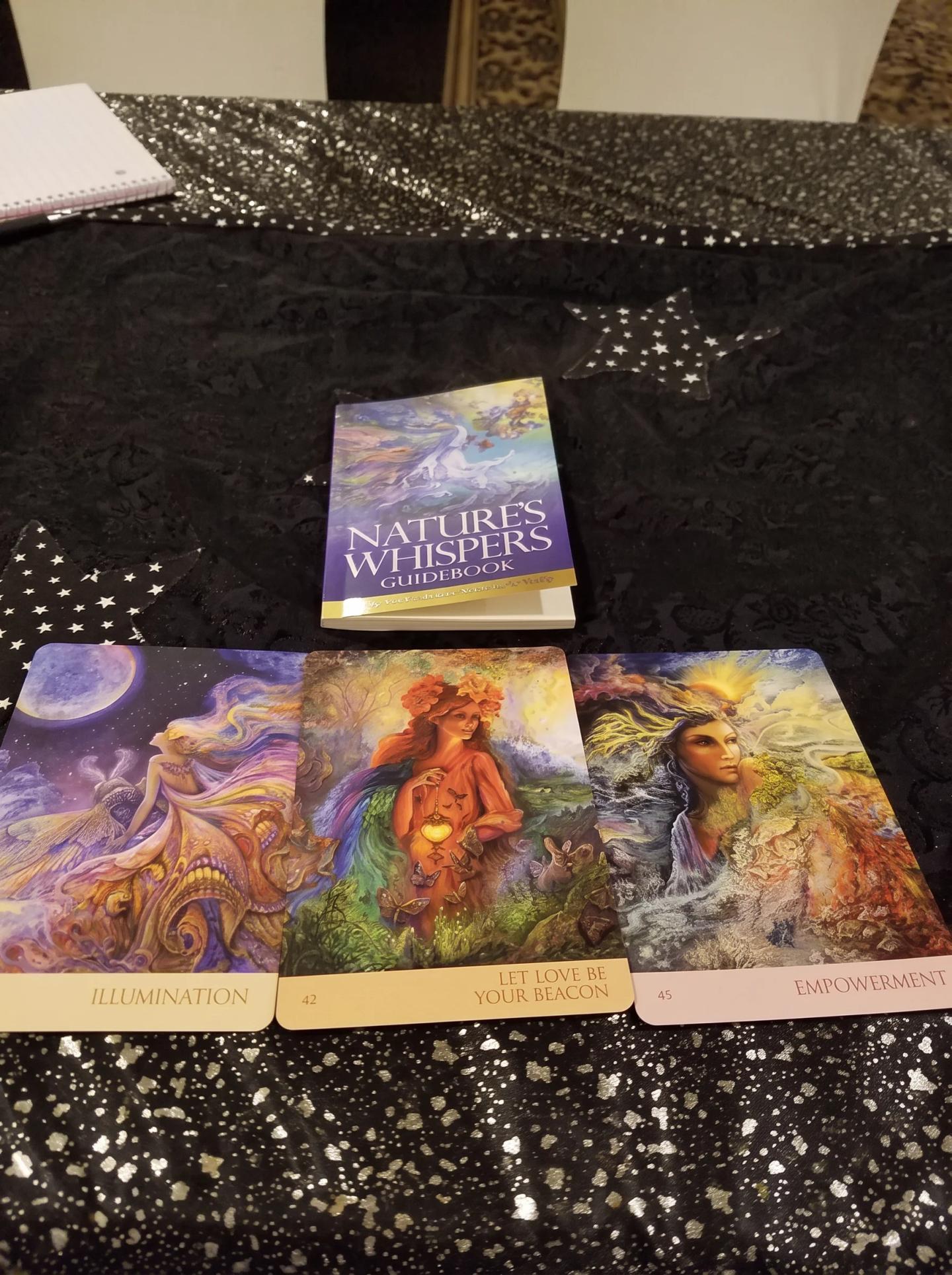 Three colorful Nature's Whispers oracle cards laid out on a star-patterned cloth