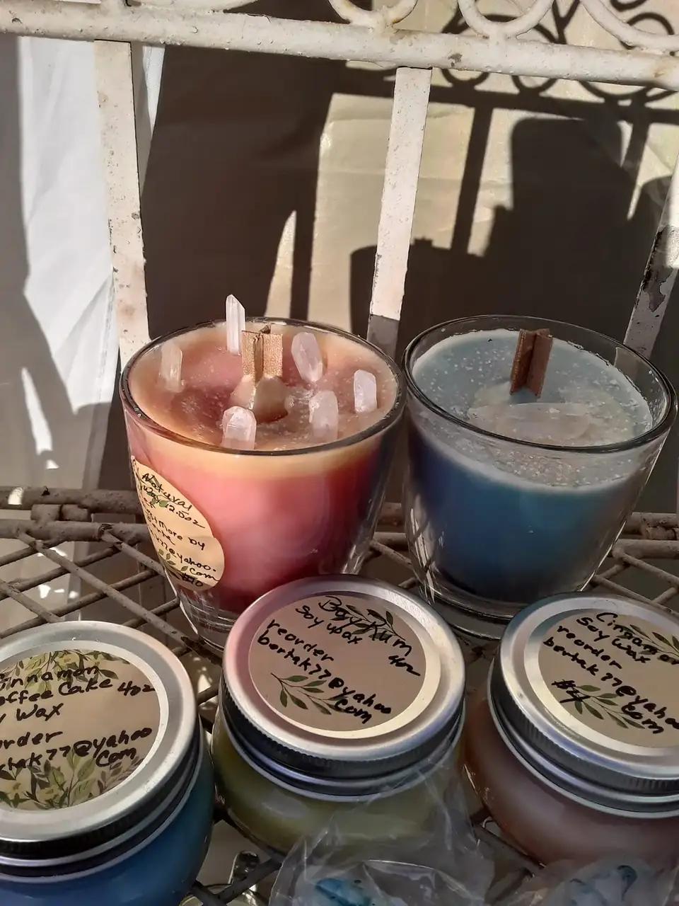 Hand-poured candles in tins at Berta's table