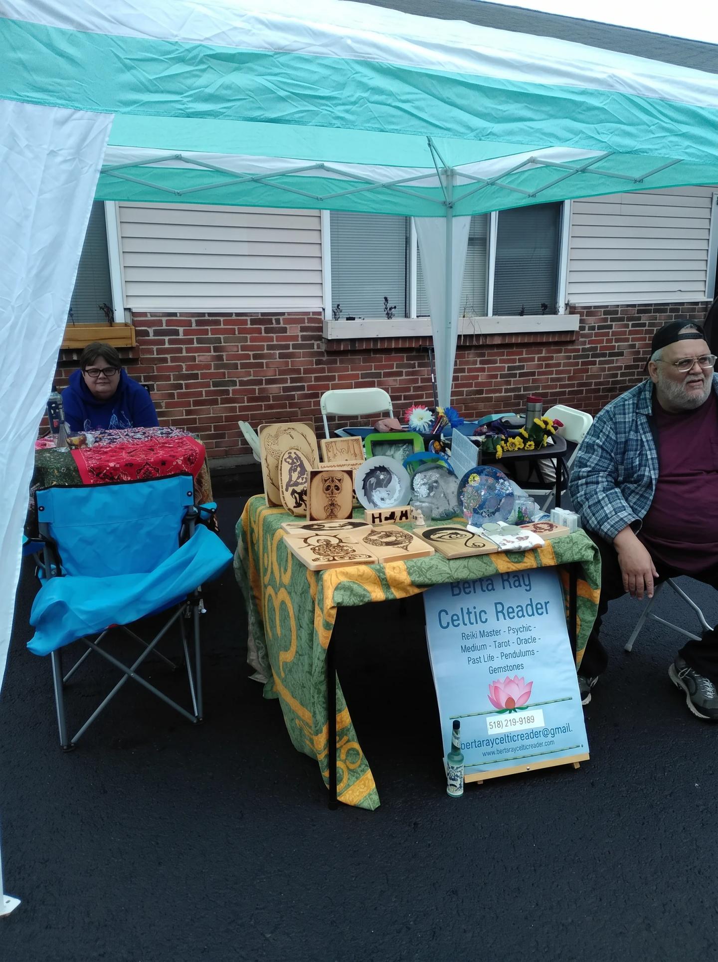 Rev. Berta Kay Celtic Reader booth displaying spiritual artwork under an outdoor tent