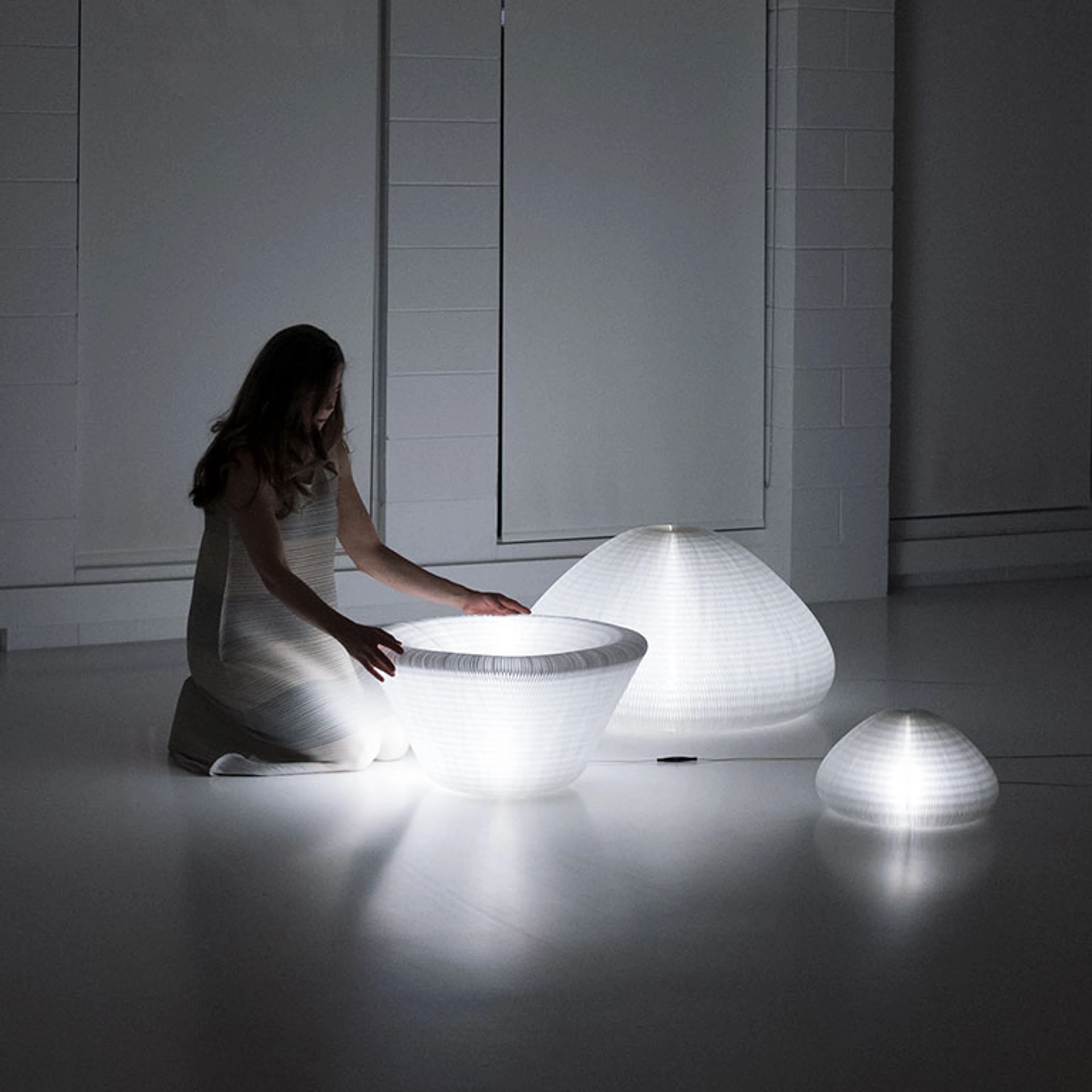 A molo employee demonstrates urchin softlight's shifting form at London Design Week.