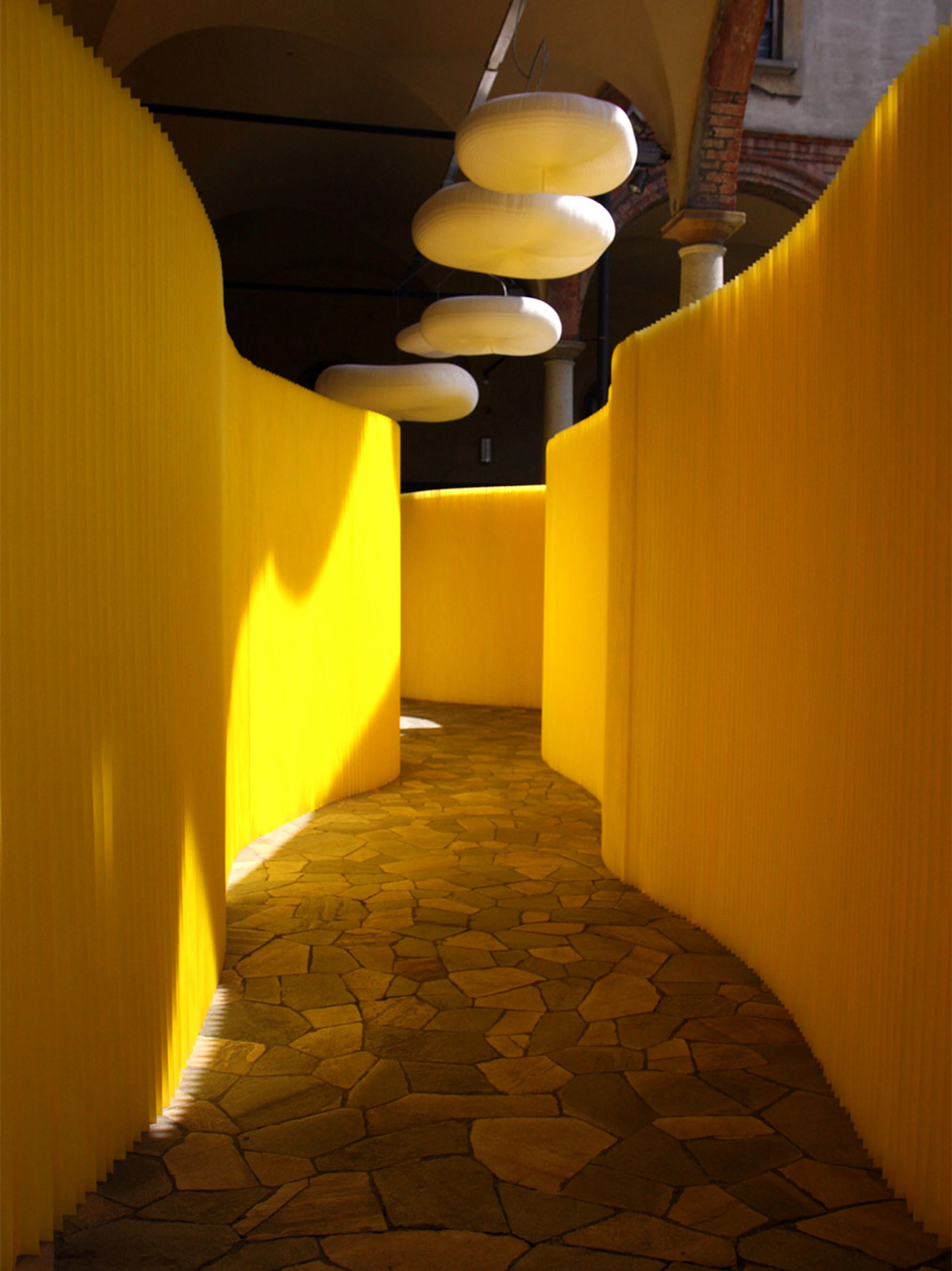 yellow textile softwalls and cloud softlight mobiles installed as part of paper music at MOST in Milan.