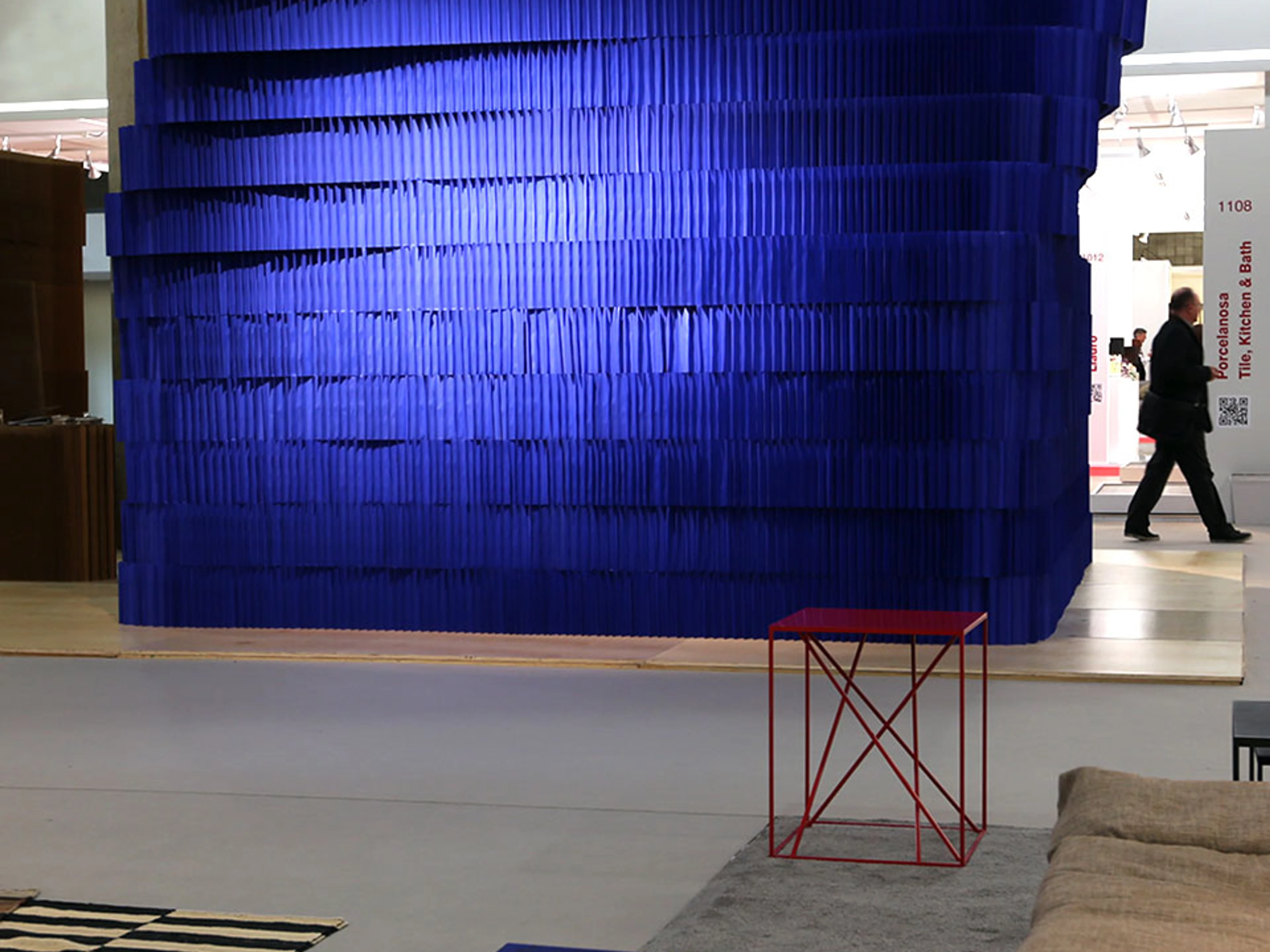 A stack of flexible paper building blocks create a torqued room at ICFF - acoustic design