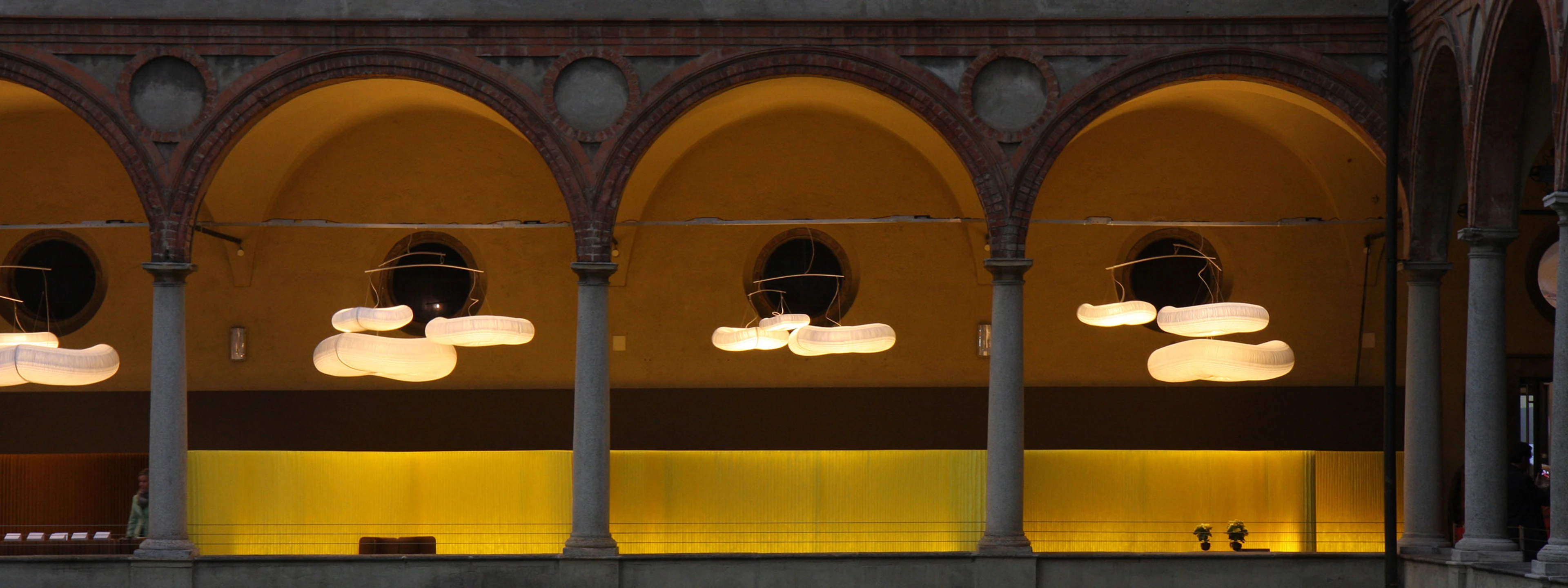 yellow textile softwall with cloud mobiles in Italy for the paper music exhibition - acoustics