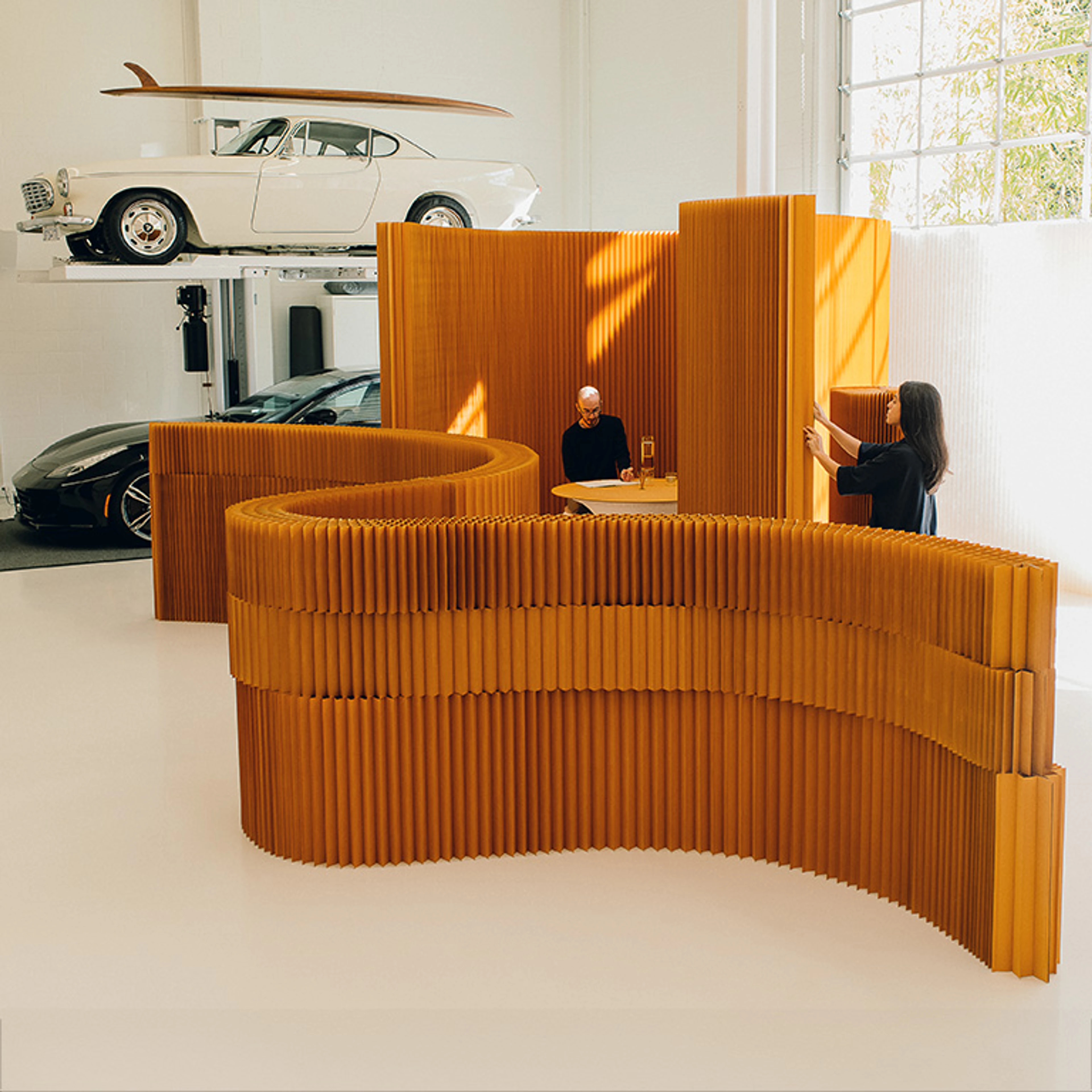 modular wall and furniture system softwall + softblock is a modular system of flexible space partitions with standard heights ranging from 1 – 10 feet tall (30.5 centimetres – 3.05 meters). Elements can be stacked vertically or connected horizontally by their magnetic end panels—making it possible to create endless lengths and impressive heights, stacking and linking walls and blocks to shape immersive environments. folding, flat pack furniture including tables and seating is available in the same aluminum textile finish as well as complimentary colours.