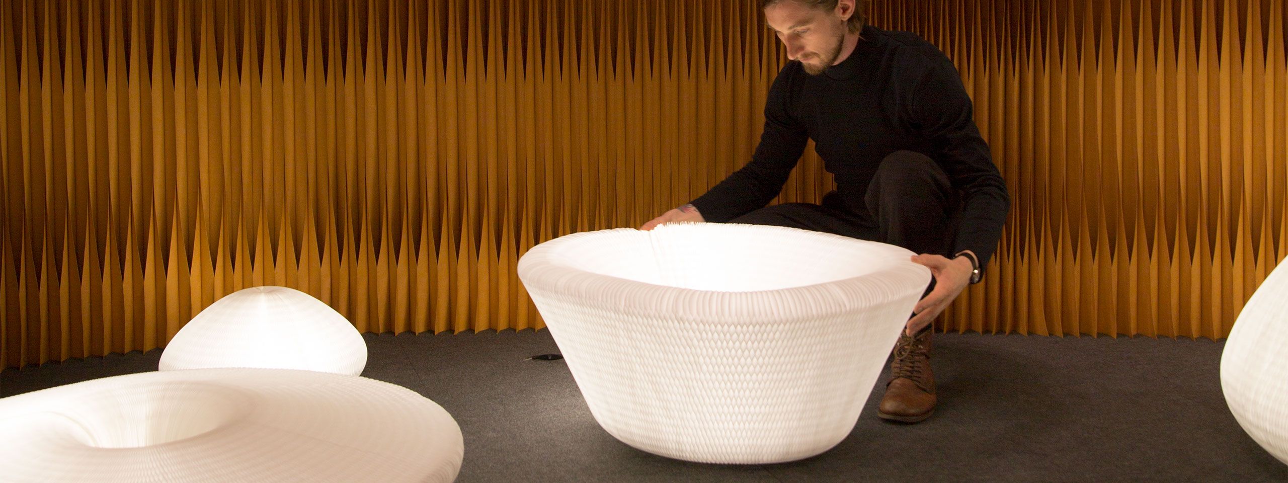 a molo employee demonstrates the various shapes of urchin softlight.