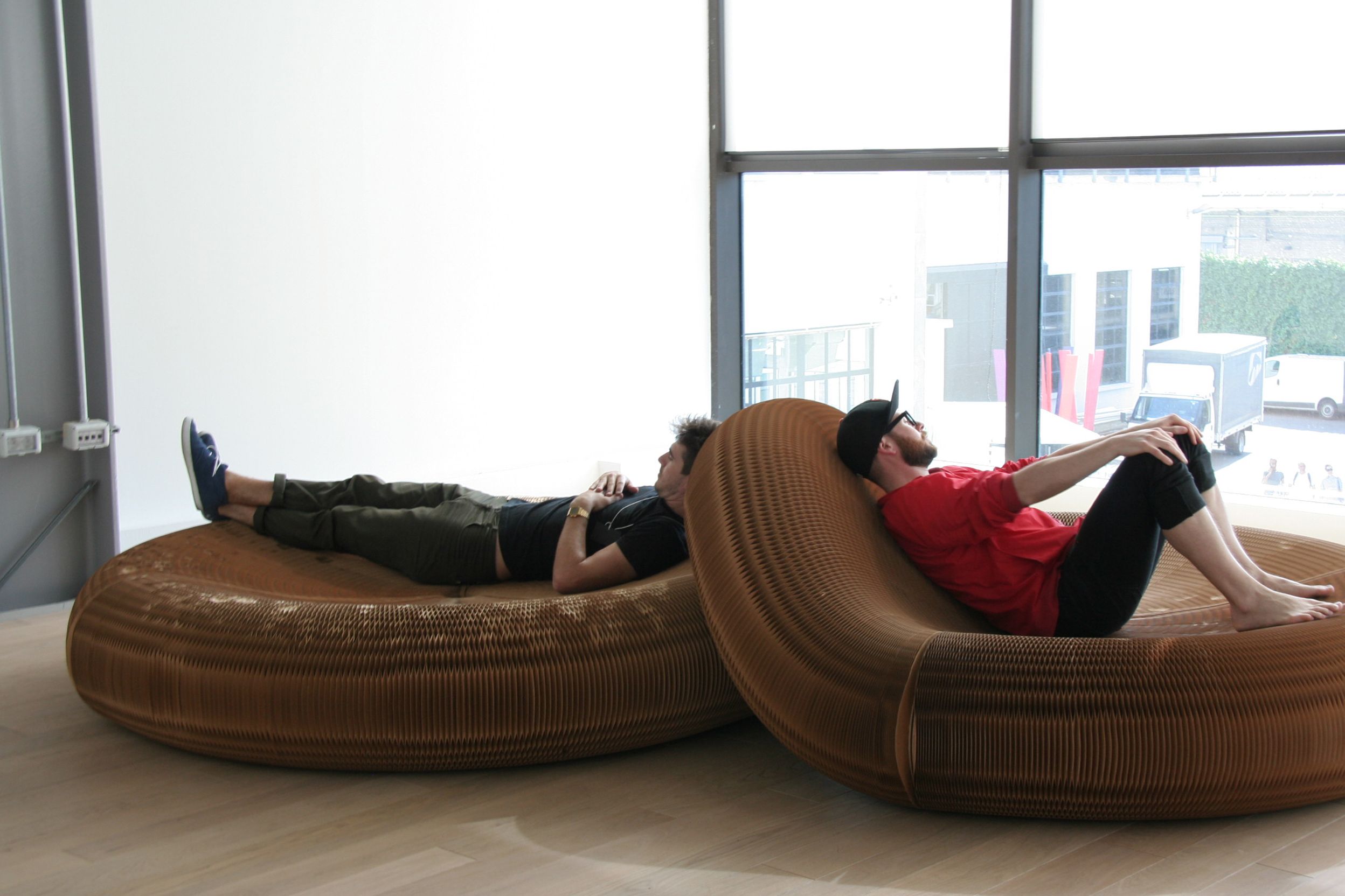 Two men take a rest on softseating lounger.