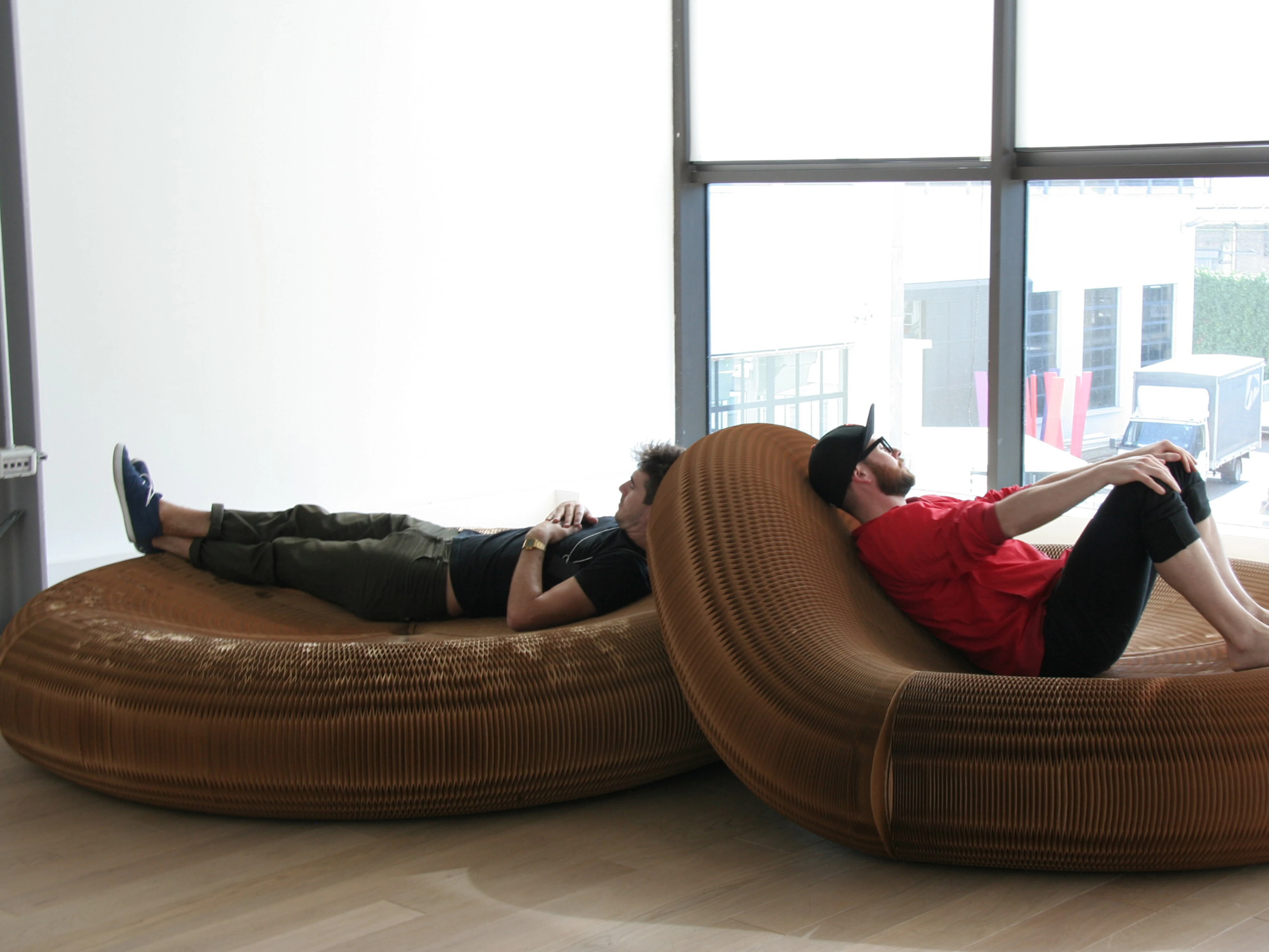 Two men take a rest on softseating lounger.