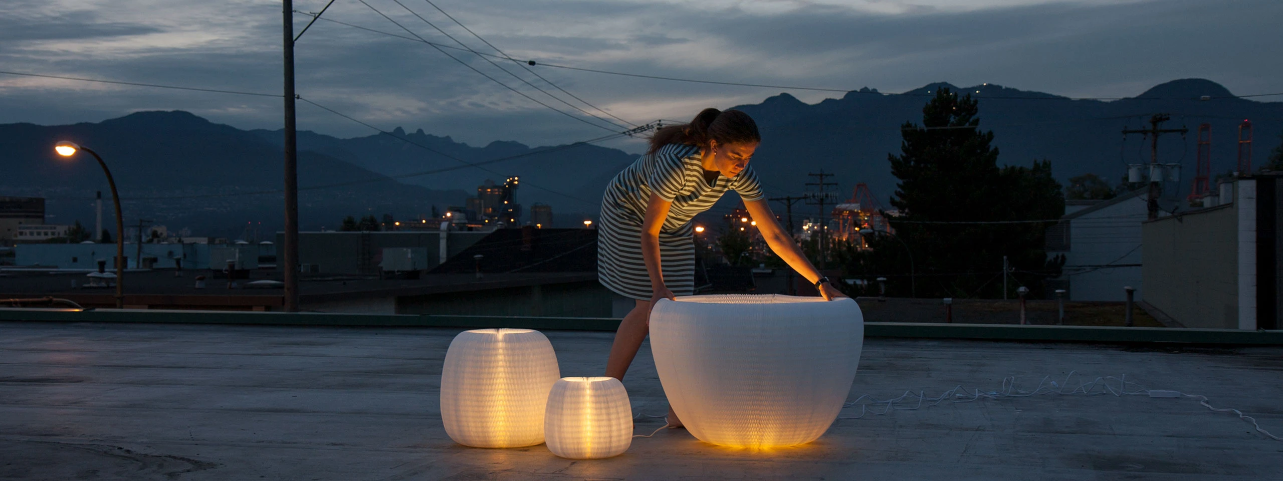 Stephanie Forsythe adjusts three urchin softlights under the night sky.