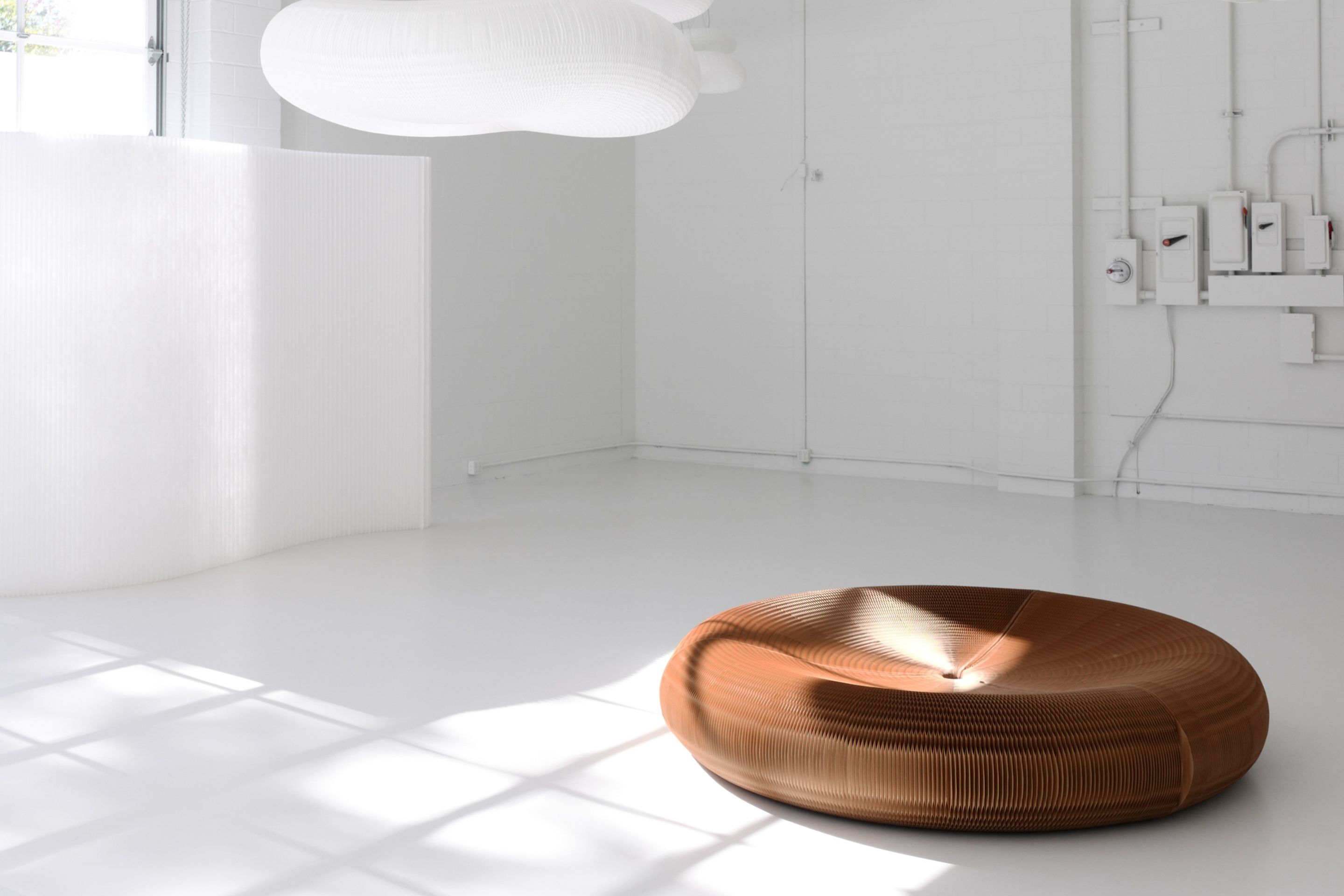 The result is a generously proportioned piece of paper or textile furniture—shared seating for living or events.