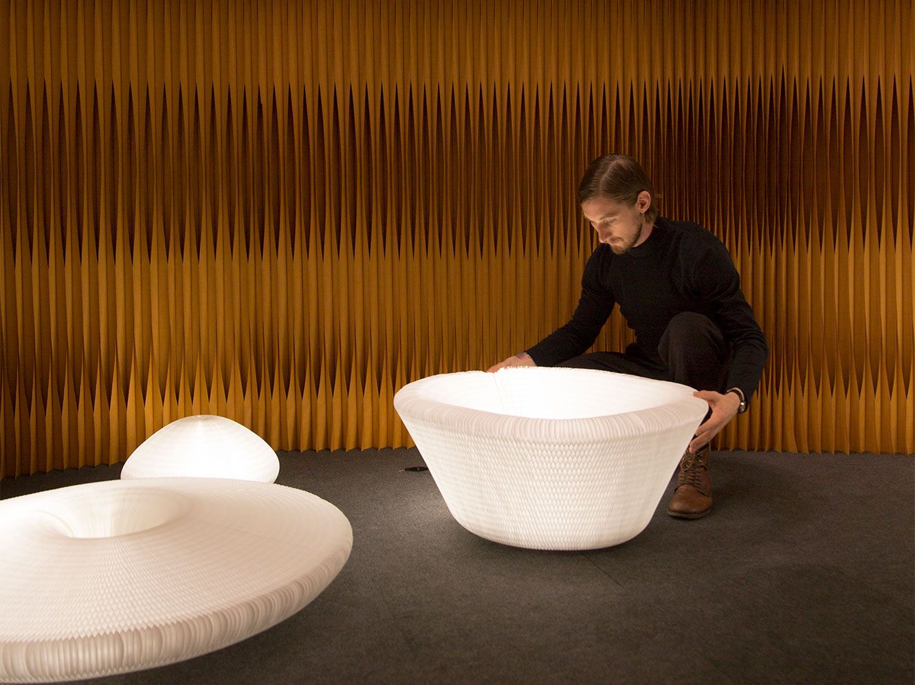 a molo employee demonstrates the myriad shapes of urchin softlight.