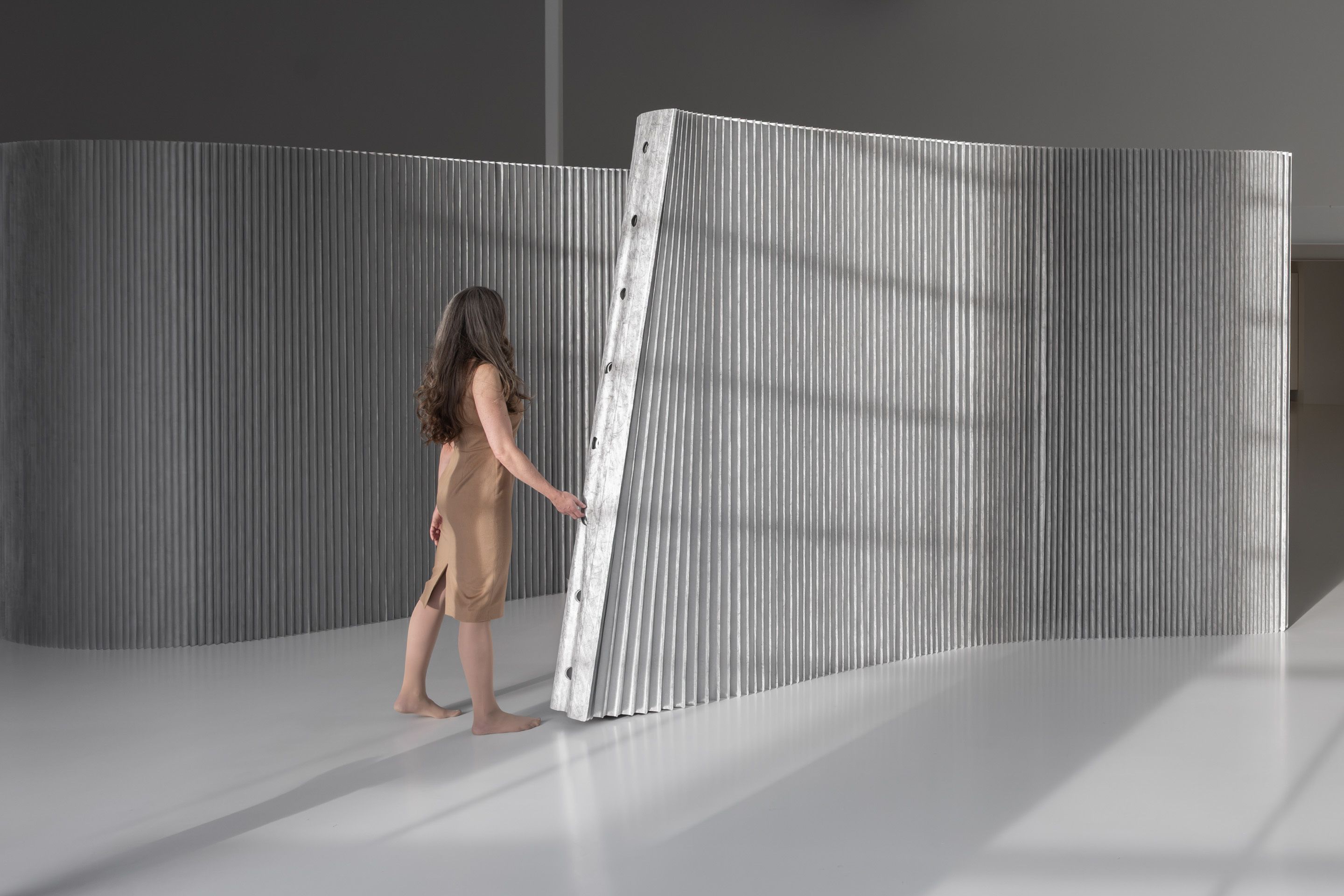 Tunnels serve as convenient handles for stretching or adjusting the wall's position, and integrate with a range of optional accessories.