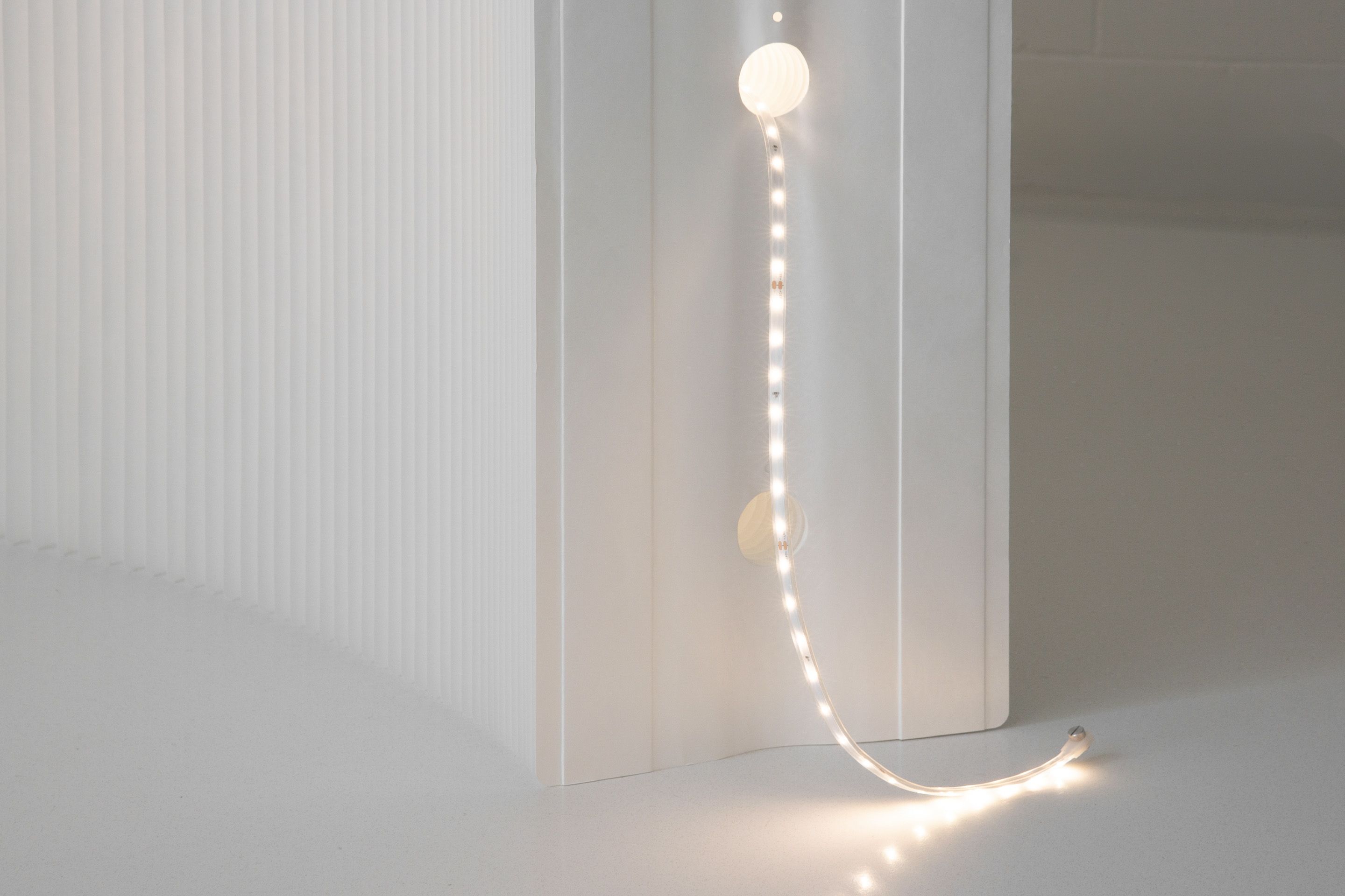The LED ribbons thread through the interior tunnels of softwall + softblock, and fasten to each end panel to stay in place.