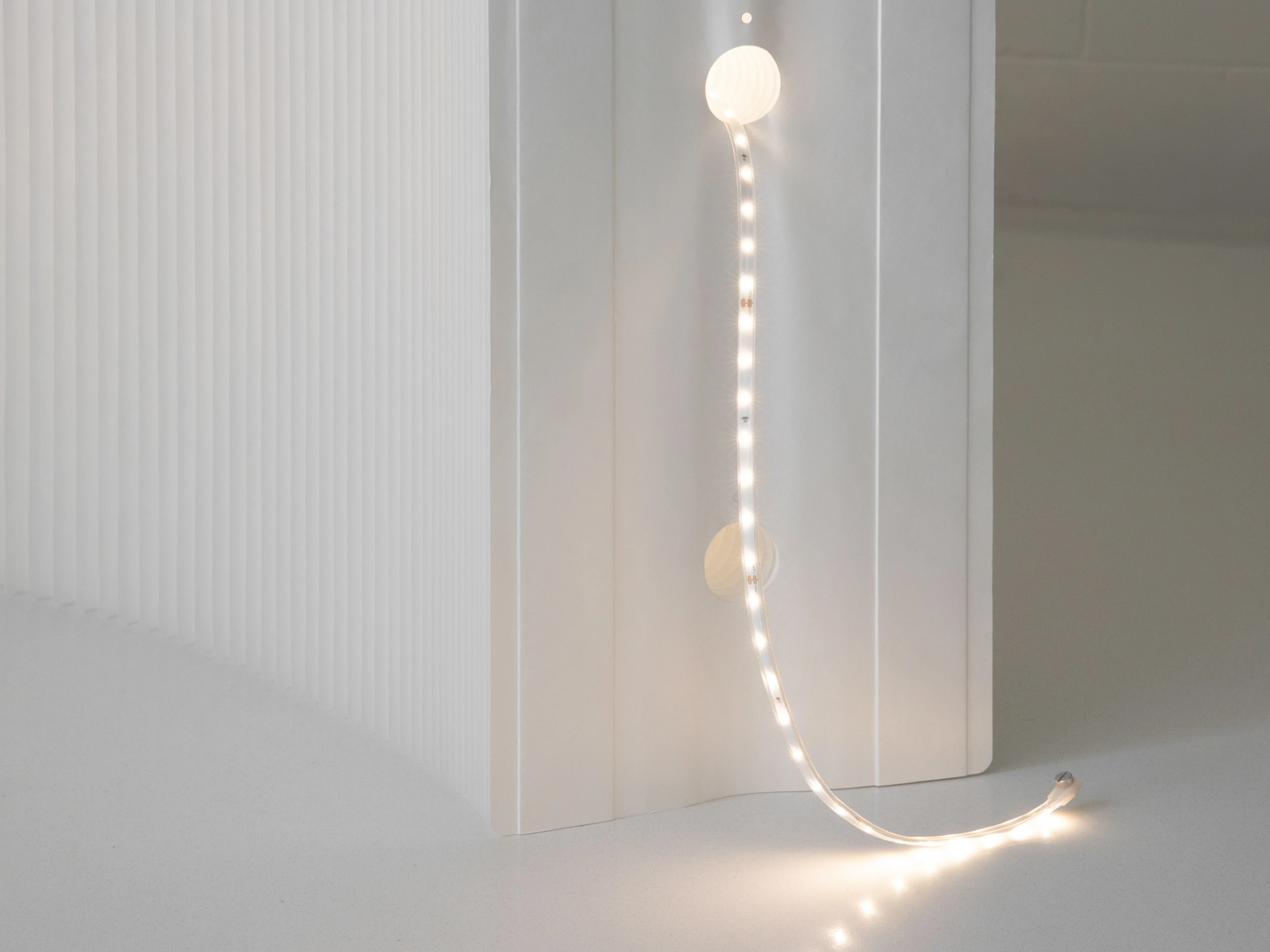 The LED ribbons thread through the interior tunnels of softwall + softblock, and fasten to each end panel to stay in place.