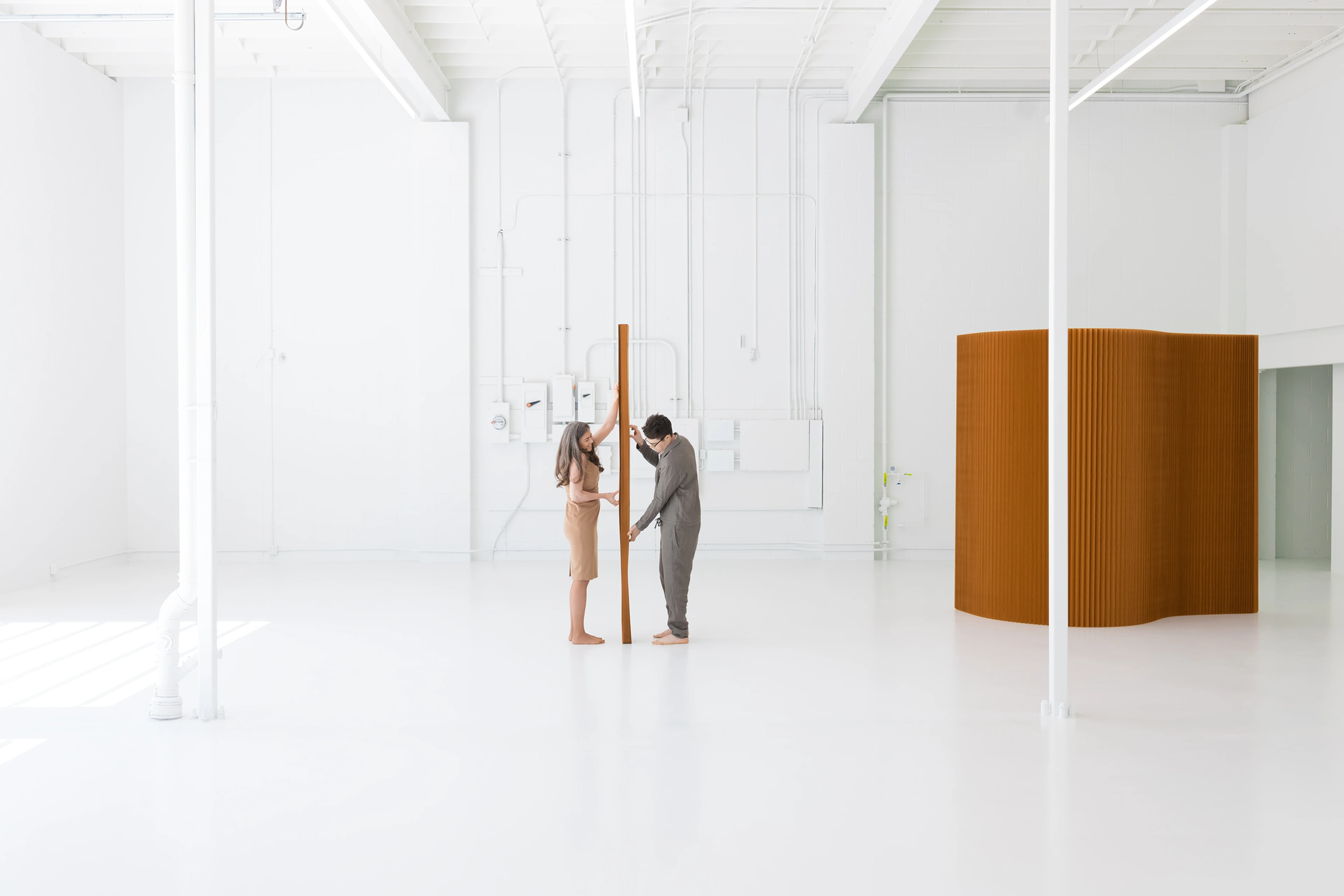 two people prepare to stretch molo brown paper partition