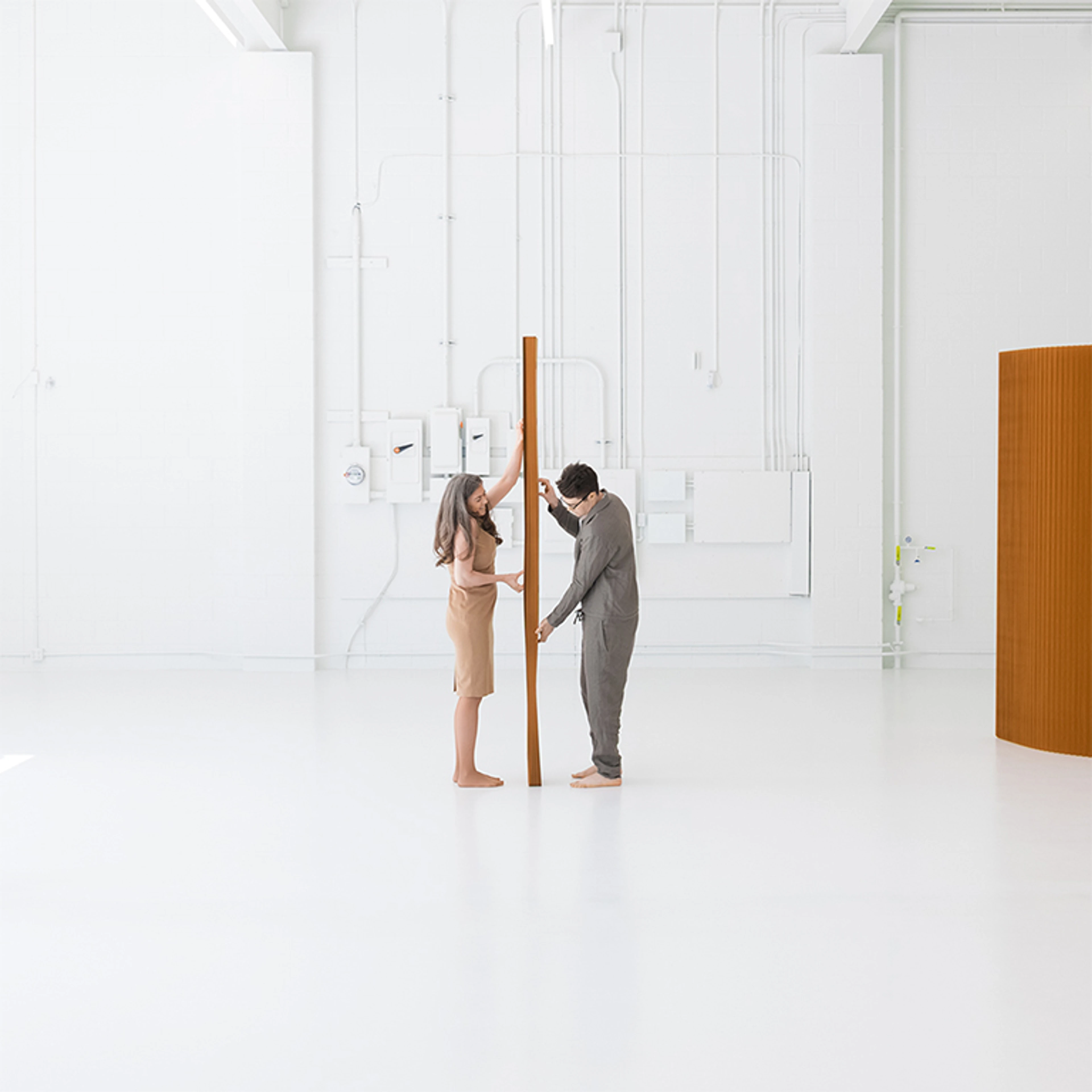 two people preparing to open brown softwall