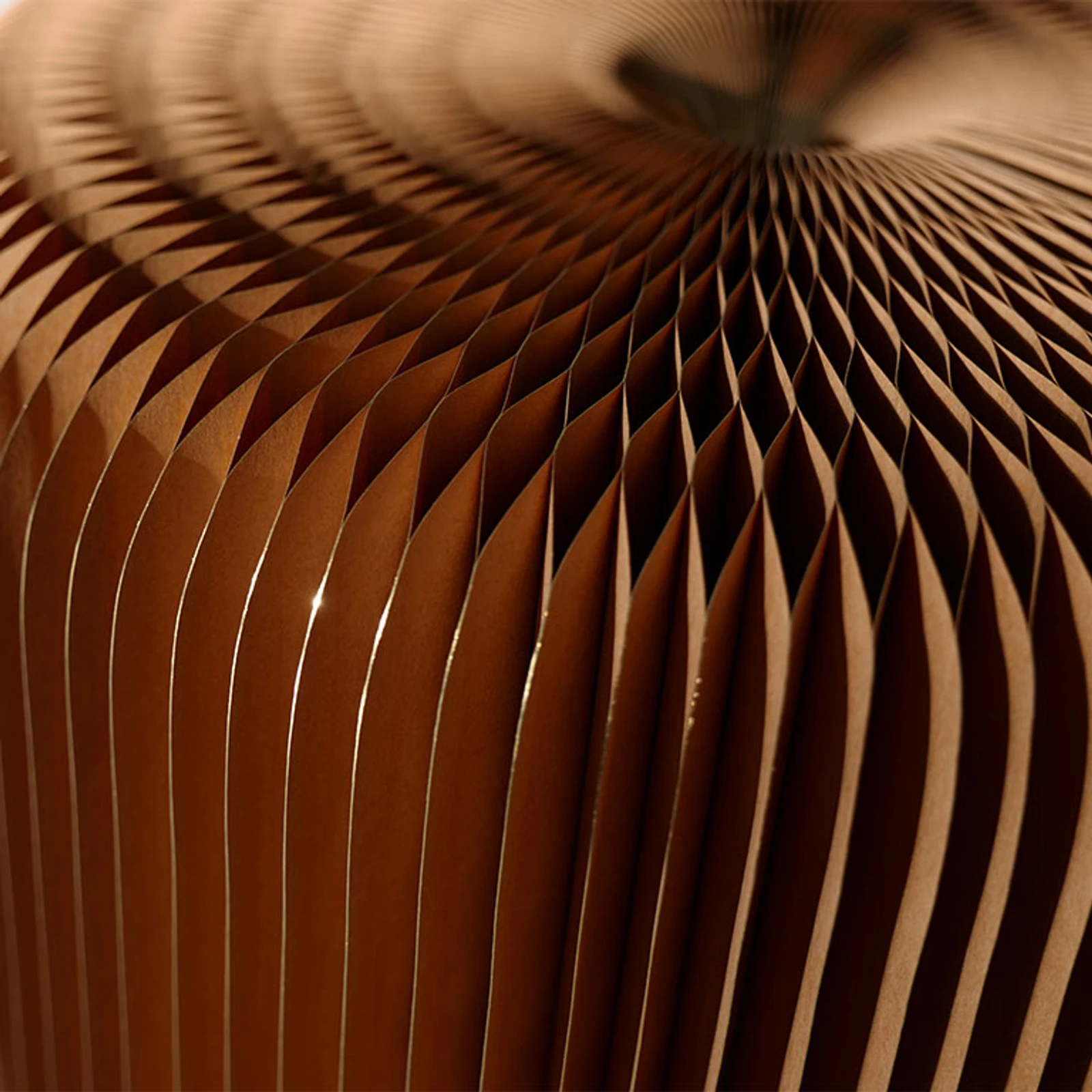 flexible seating - light reflects off the gilded paper pleats of a softseating fanning stool