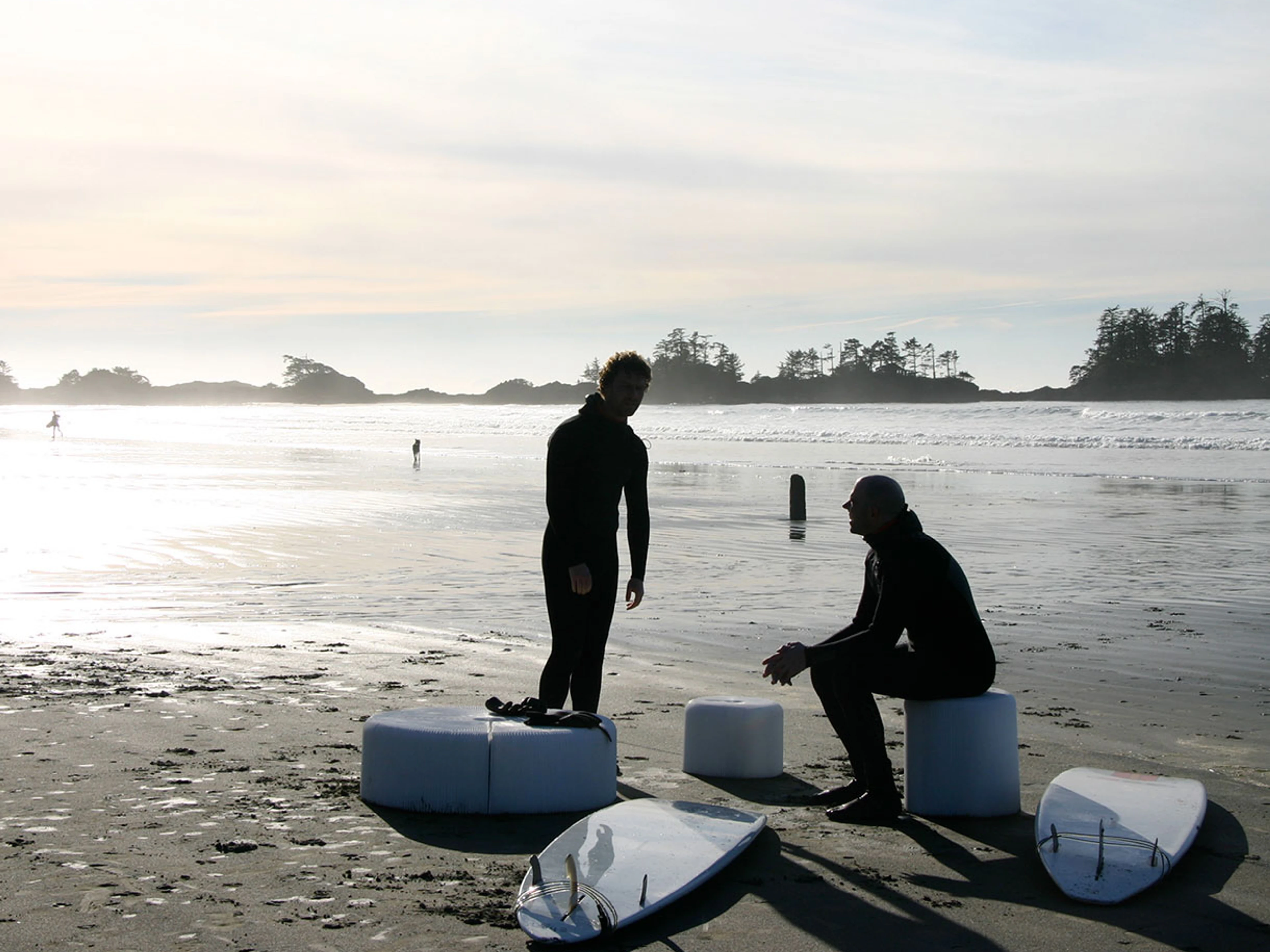 Surfers sit on softseating folding stools. Great beach furniture, this portable seating comes with carry tote. This is the water resistant textile version of original paper stool by molo.