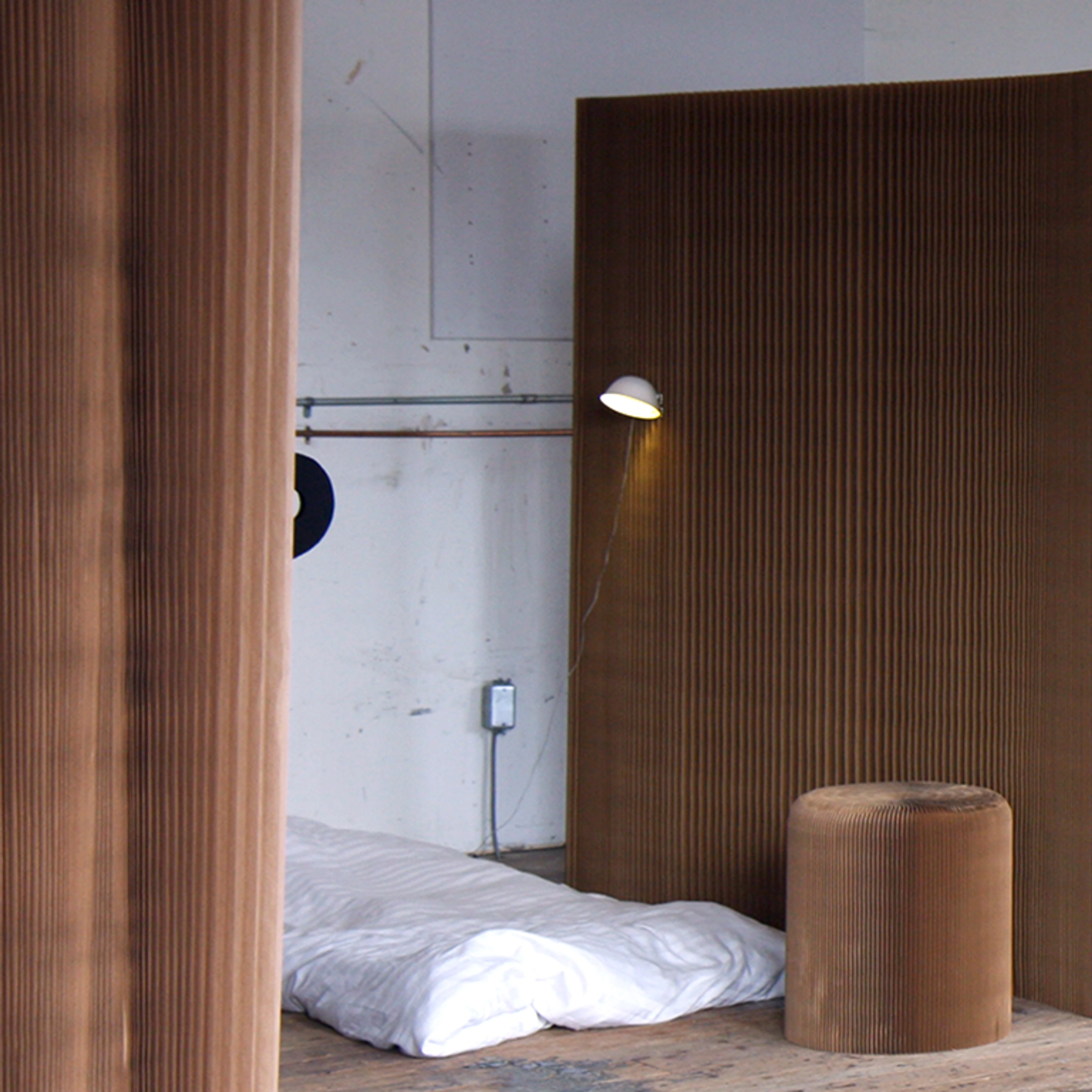 softshelter with lamp, paper seat and small cot.