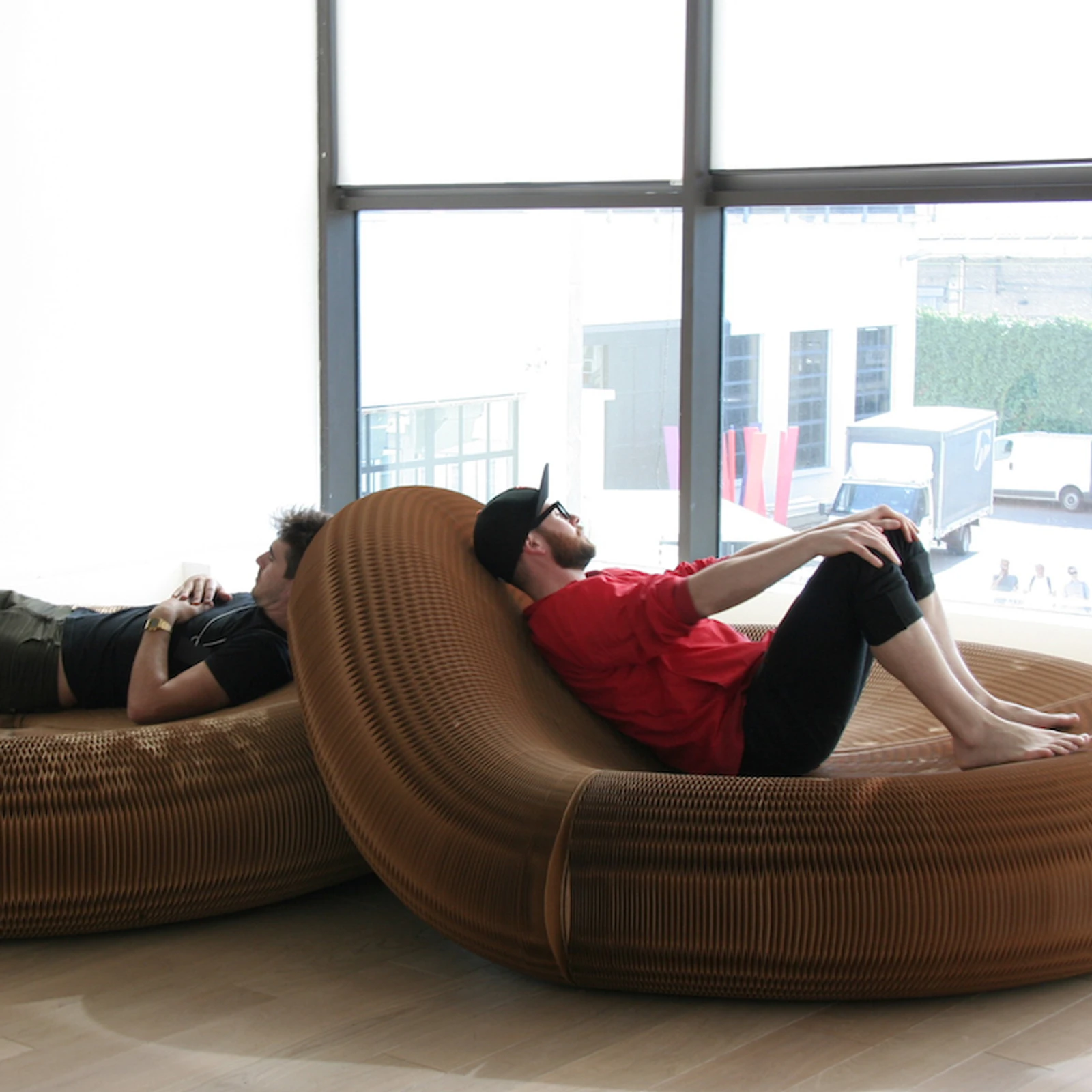 Two men take a rest on softseating lounger.