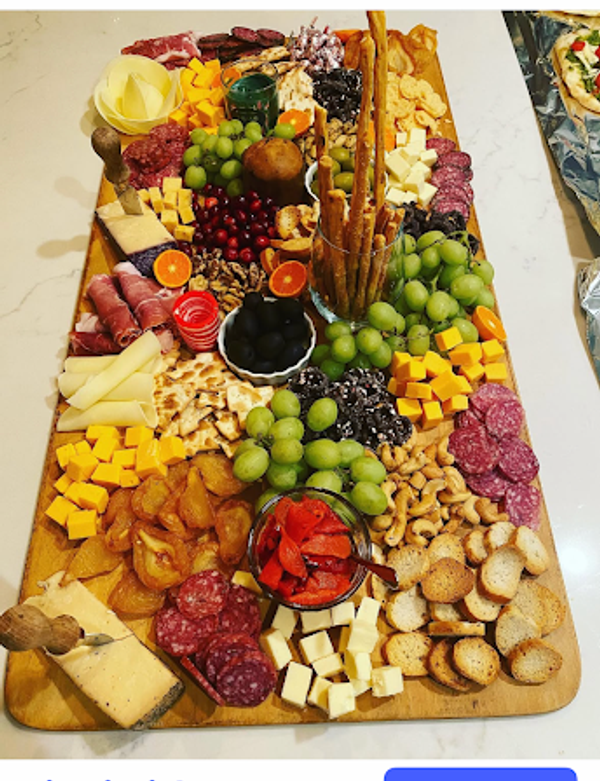 Large antipasto spread with meats, cheese, fruit and crackers