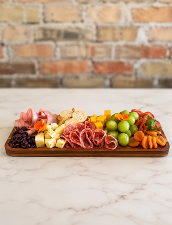 Antipasto board with cured meats, cheese and fruit