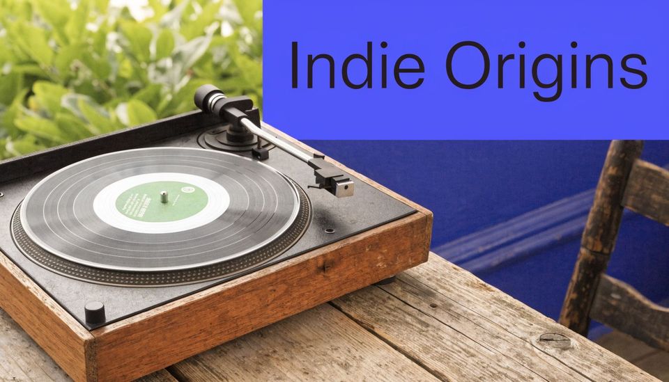 A vintage wooden record player sitting on a weathered table with a blue wall in the background.
