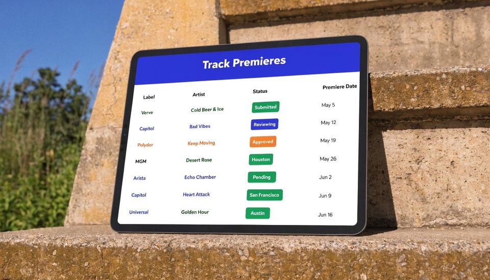 A digital tablet displaying a track premiere schedule table with record labels, artists, and status updates.