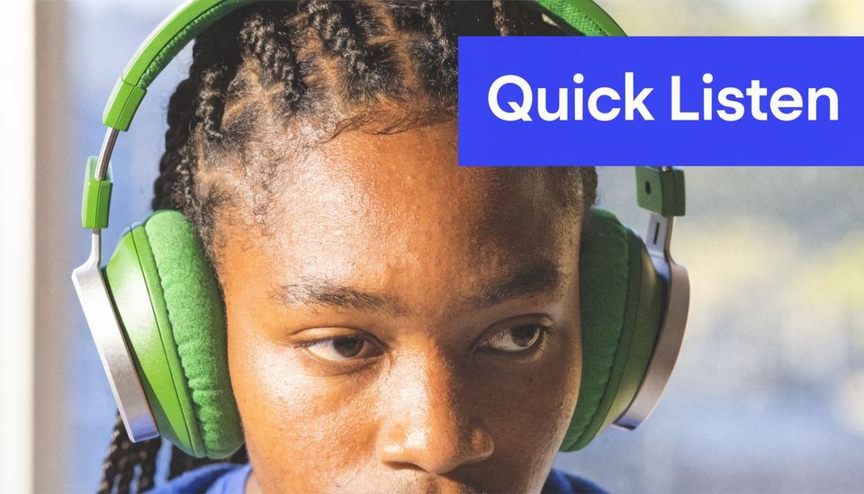 A young woman wearing vibrant green headphones focusing intently while listening to something.