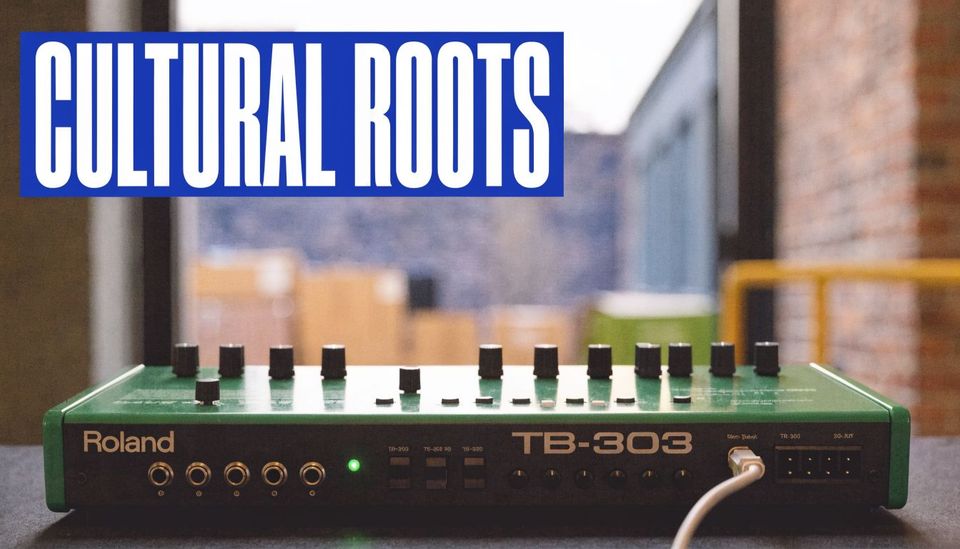 A Roland TB-303 synthesizer sits on a table with the words CULTURAL ROOTS displayed above it.