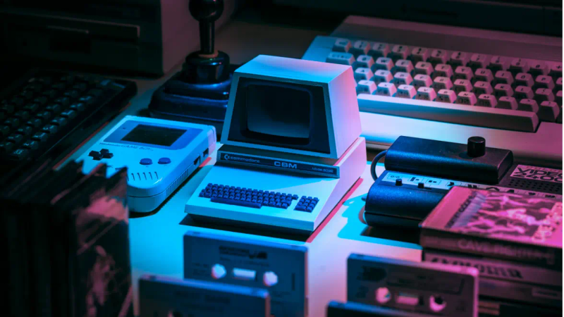 Old computer surrounded by other retro computer devices