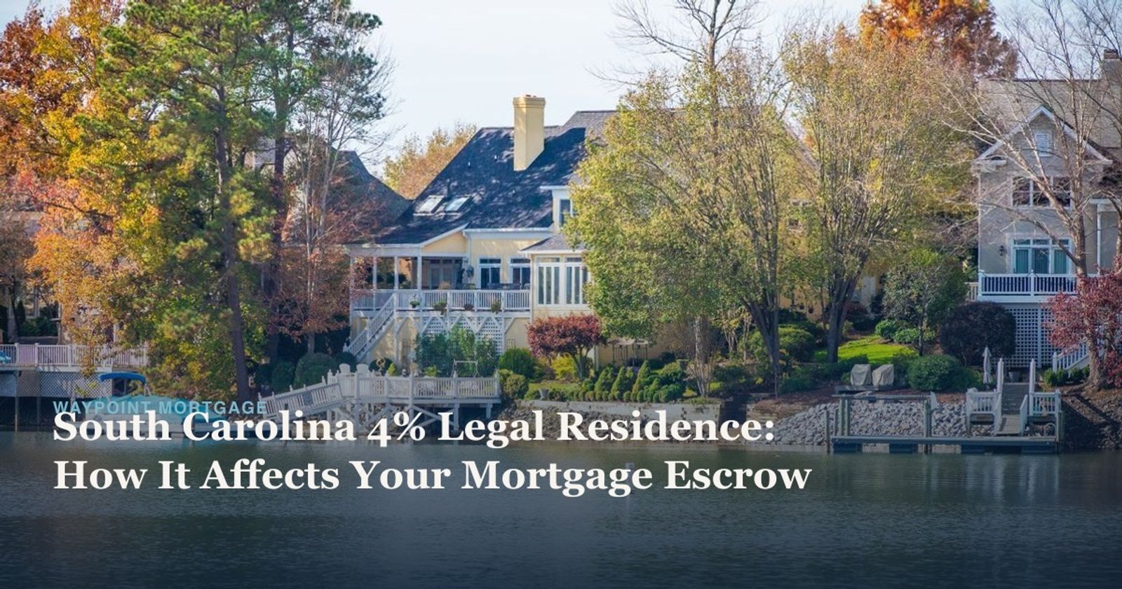 Picturesque lakeside home surrounded by vibrant autumn foliage.