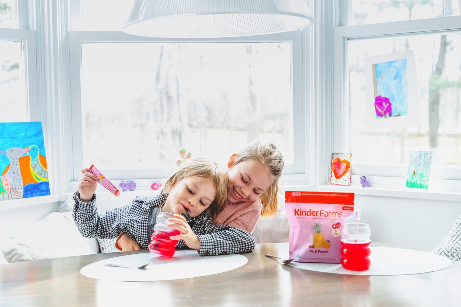 Photograph of two children with Kinder Farms products