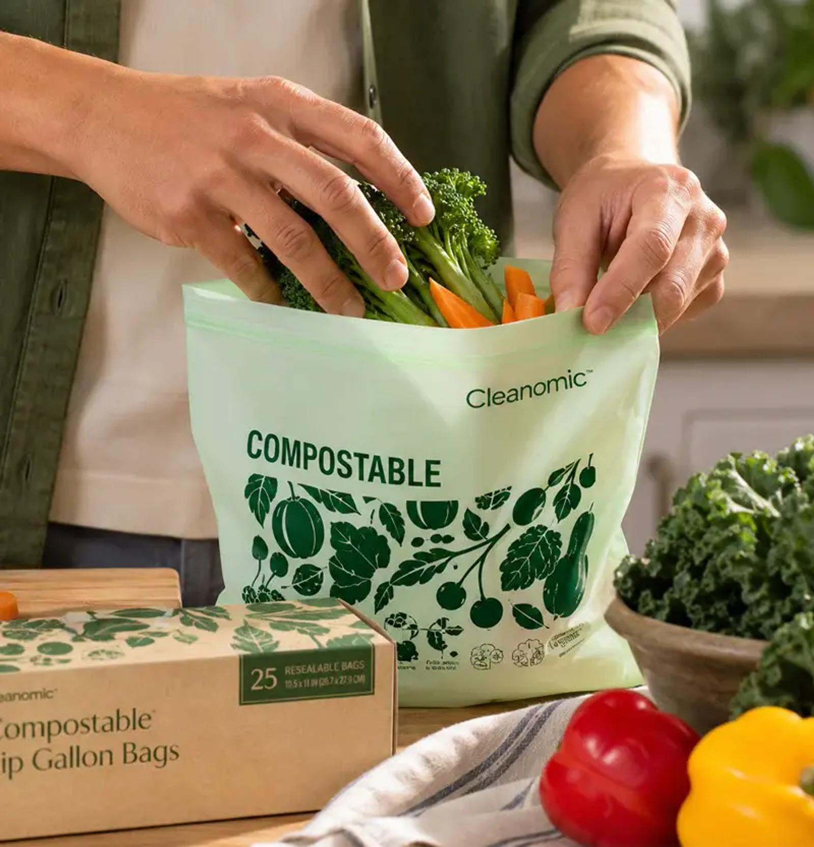 Person placing broccoli and carrots into a Cleanomic compostable resealable gallon bag in a kitchen