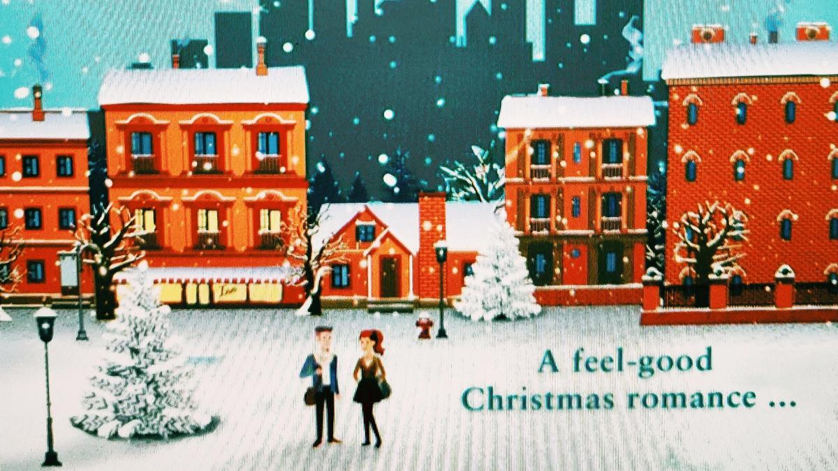 Cover Detail from Christmas at the Little Knitting Box by Helen J. Rolfe showing 2 people walking in a snowy town scene