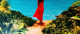 Cover detail of The Secret Path by Karen Swan showing a woman in a red dress, her back to us, looking at a beach