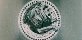 Cover detail from The Lion, The Witch and the Wardrobe by C.S. Lewis showing a medallion of a lion