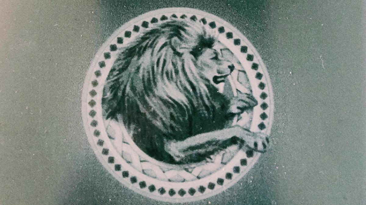 Cover detail from The Lion, The Witch and the Wardrobe by C.S. Lewis showing a medallion of a lion