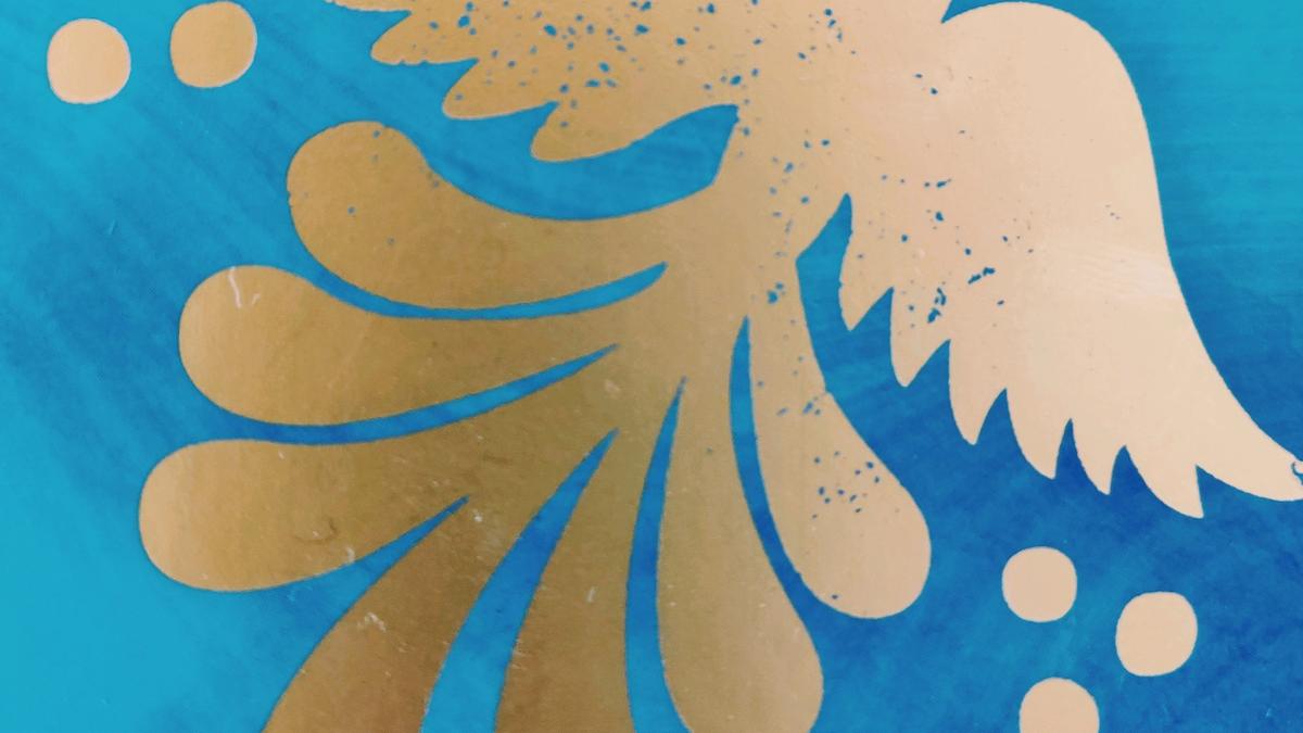 Cover Detail of American Dirt by Jeanine Cummins showing a gold foil bird on a blue background