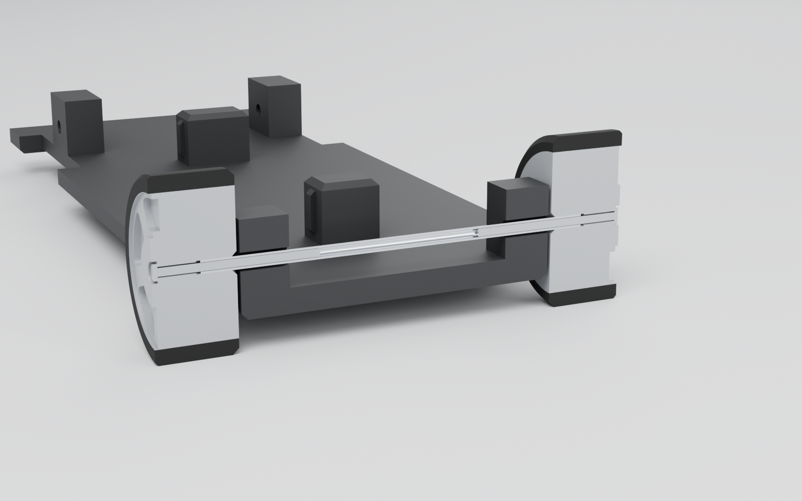 Cutaway of the front axle: a hollow metal shaft running through the chassis blocks, with the wheels fixed on each end