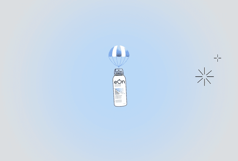 hand holding eOn mist and spraying it into the air.