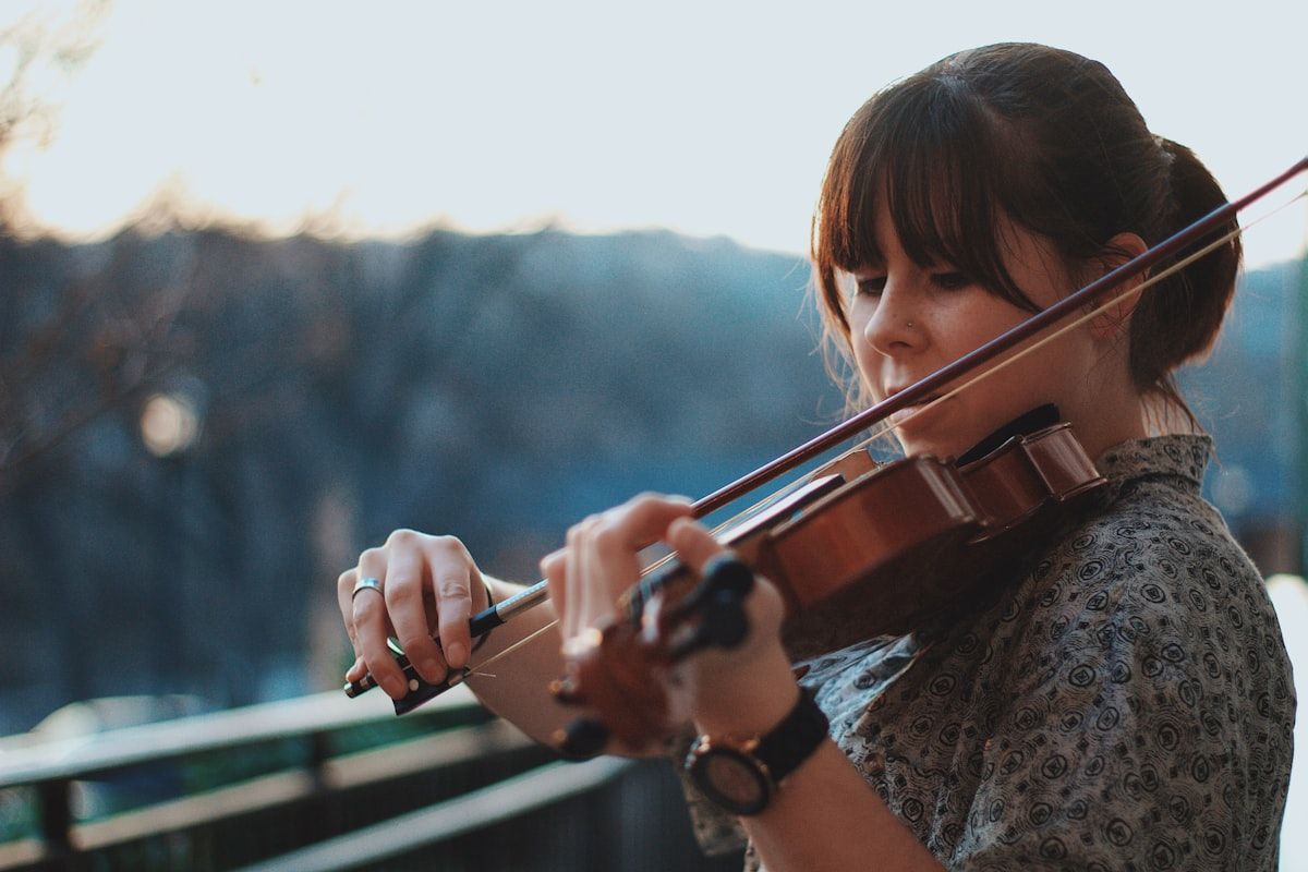 A violinist performing with sheet music close by.
