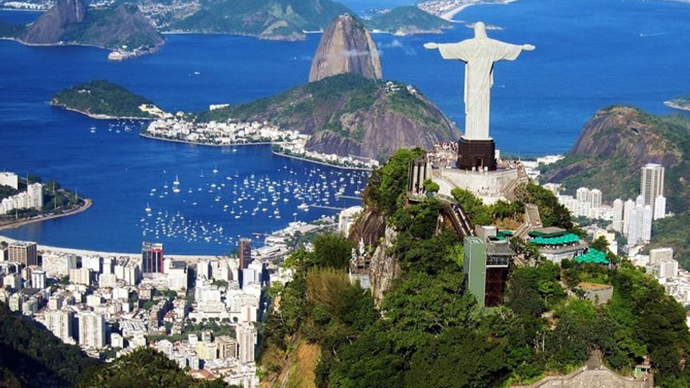 Panoramic view of Rio de Janeiro, featuring Christ the Redeemer statue, Sugarloaf Mountain, and Guanabara Bay.